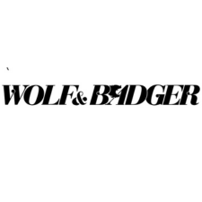 Black text logo on a white background reads "WOLF & BADGER" in bold serif font, with the silhouette of a wolf howling inside the letter "A" in "BADGER." The ampersand is stylized to blend with the font.