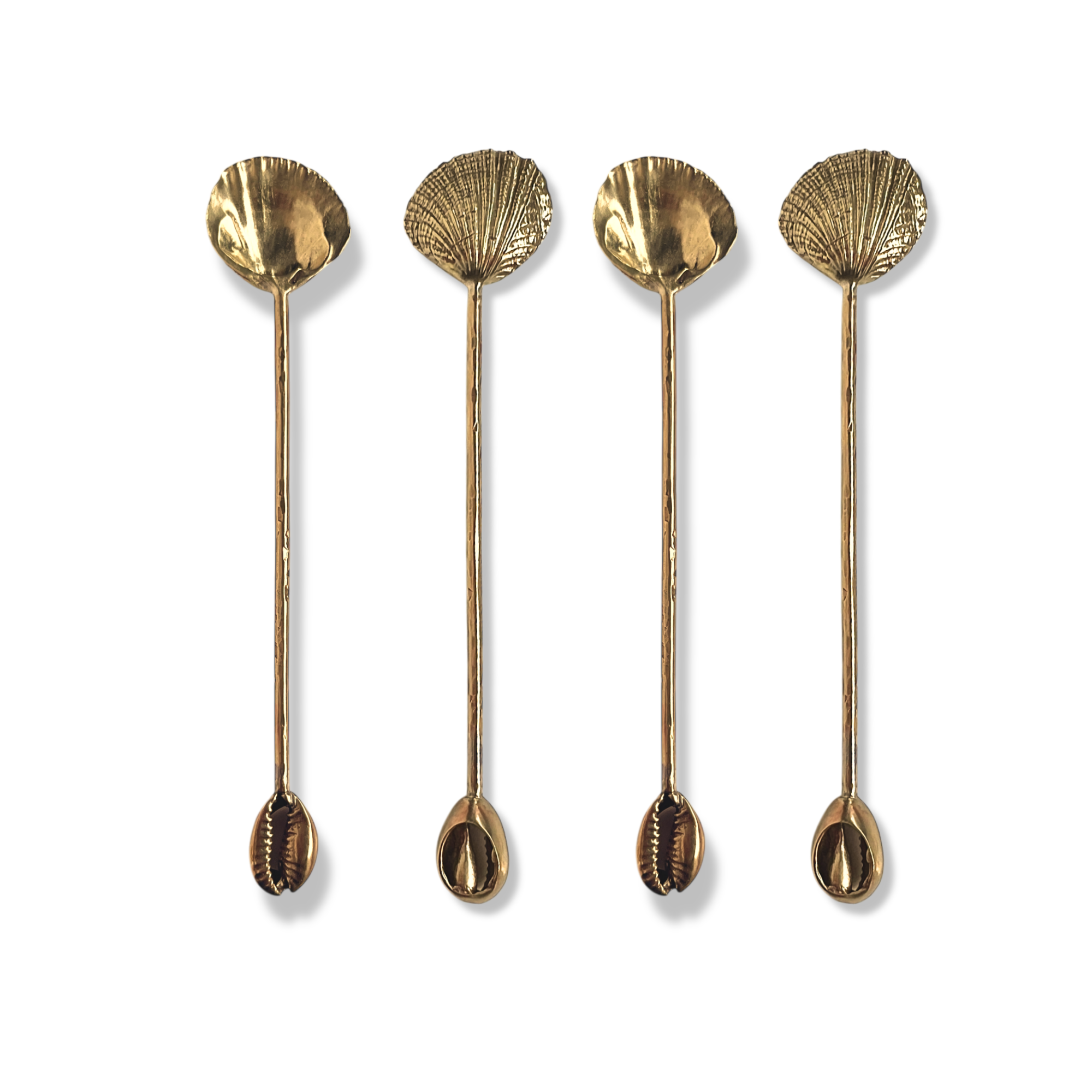 Four gold-toned spoons with decorative shell-like designs on the top and small, detailed shell shapes on the handles, arranged vertically against a white background.