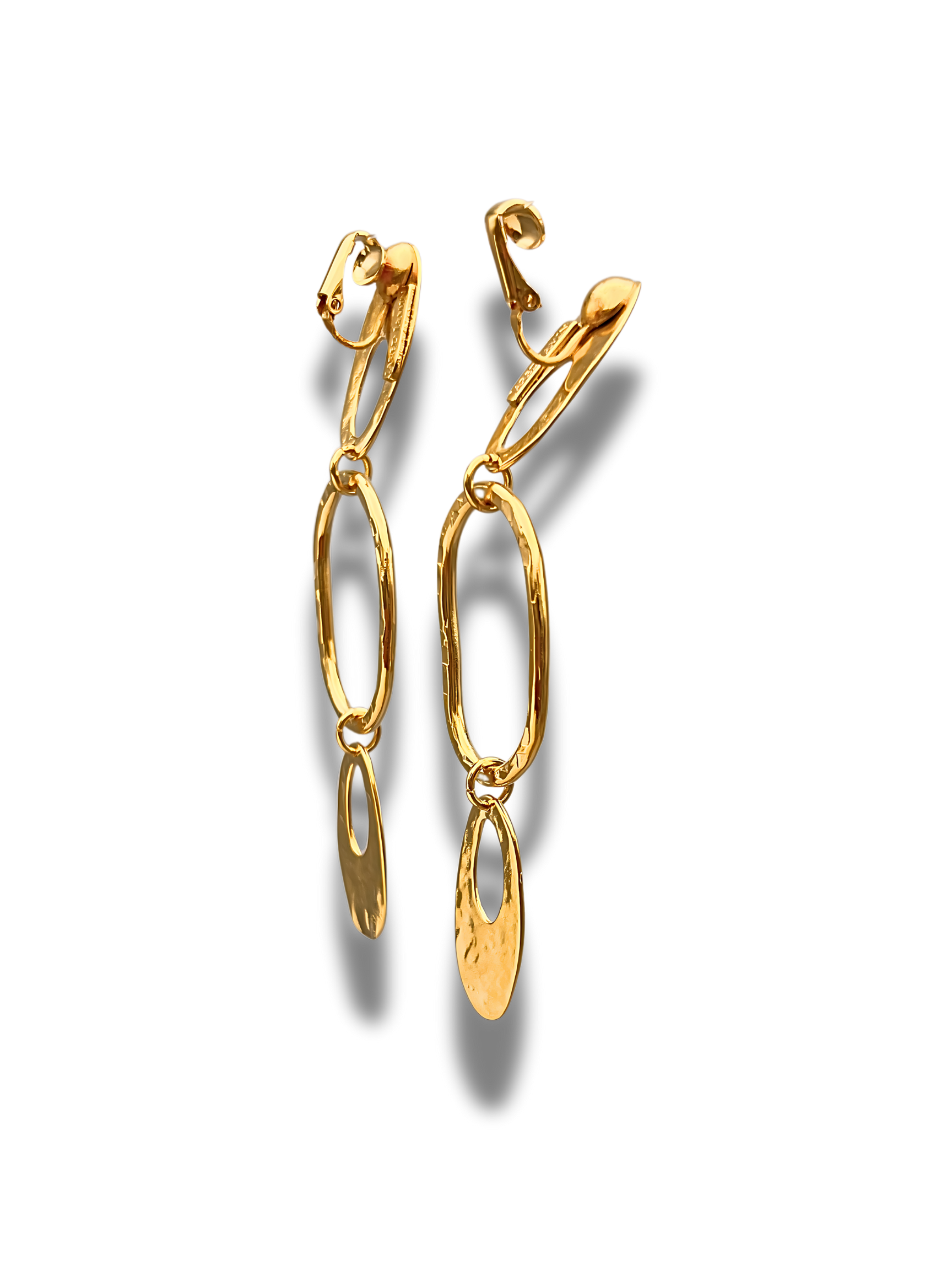 Two gold drop earrings with elongated oval links, each ending in a teardrop-shaped charm. The earrings cast soft shadows on a plain white background.