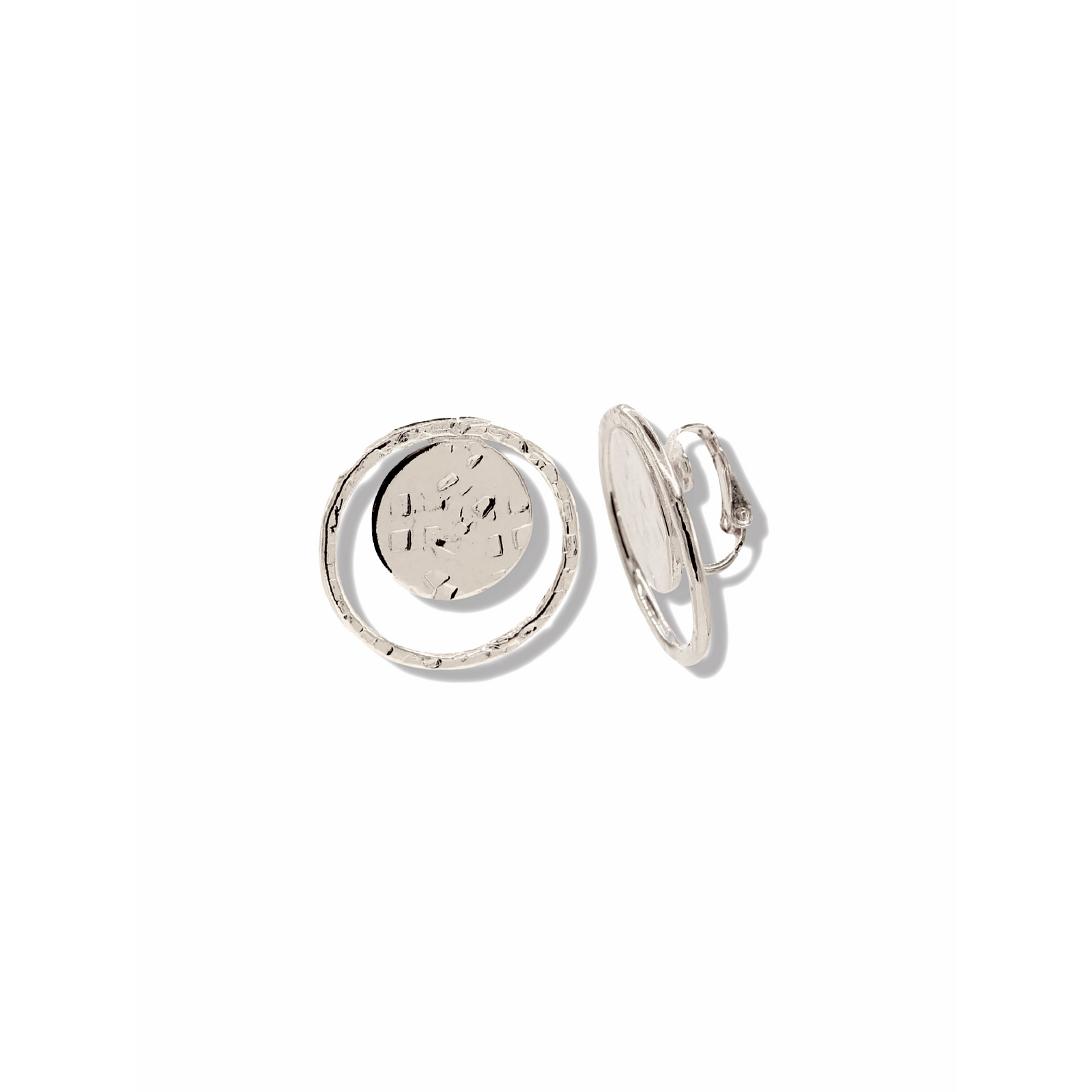 Two Silver Peacock Eye Clip On Earrings by JAREDJAMIN Jewelry Online are displayed on a white background, each featuring a round textured disk with a hammered grid pattern and an irregular hoop for a handcrafted look.