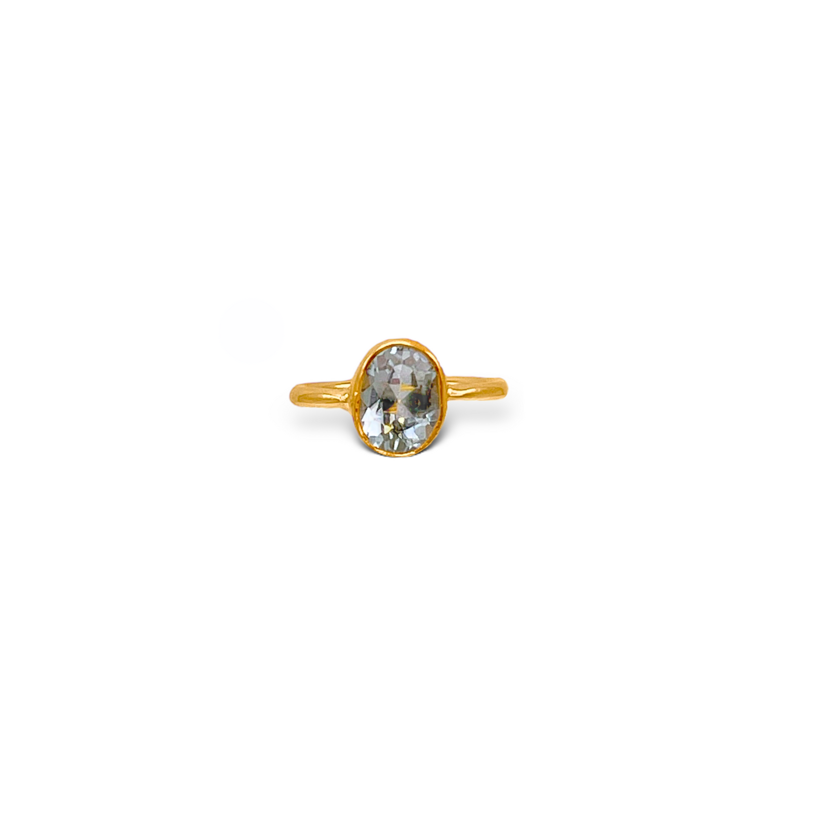 The Oval Aquamarine Gemstone Ring by JAREDJAMIN Jewelry Online features a thin gold band and an oval-cut aquamarine in a sleek bezel setting, shown against a plain white background.