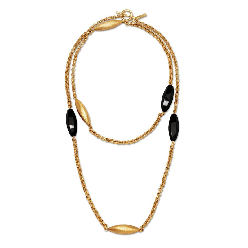 Los Zeppelin Luna Onyx collar de JAREDJAMIN Joyería Online features three mate 18k oro oval beads y three glossy black oval beads, evenly spaced sobre un artesanal oro cadena con a toggle clasp. Los design is delicado y elegante against a fondo blanco.