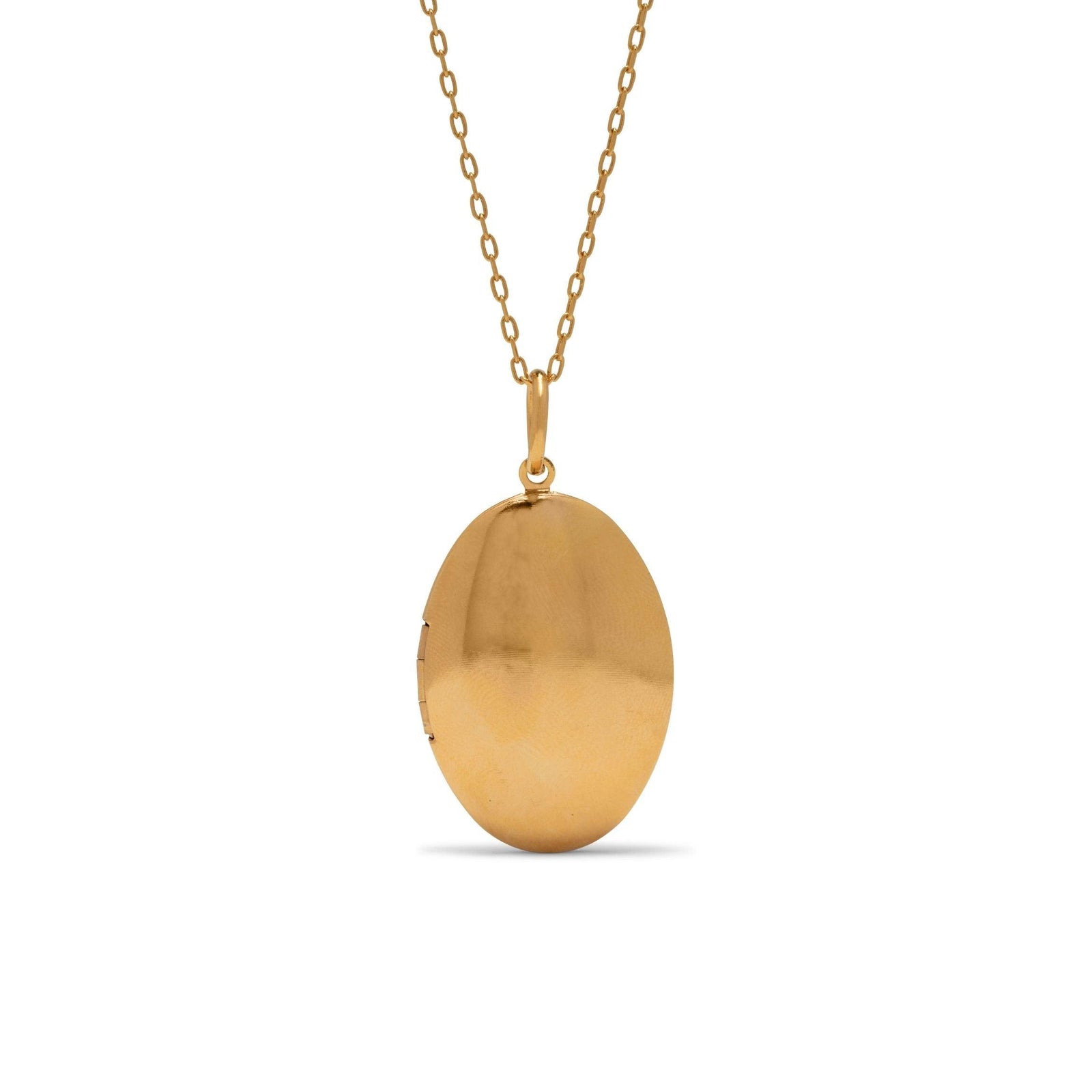 The Gold Smooth Necklace Pendant Locket by JAREDJAMIN Jewelry Online features a simple round design with an 18K gold plate finish and hinge, perfect for keeping a small photo or keepsake, hanging from a fine chain.