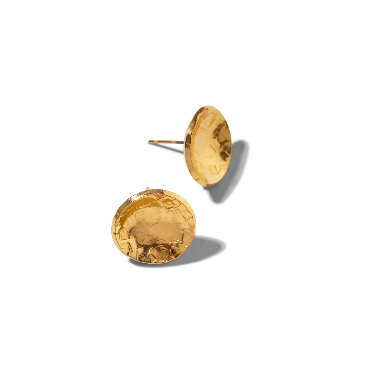 Two Buttercup Textured Stud Post Earrings by JAREDJAMIN Jewelry Online in 18K gold-plated brass are displayed on a white background—one flat, one tilted to reveal its concave shape and post—with shadows adding depth.