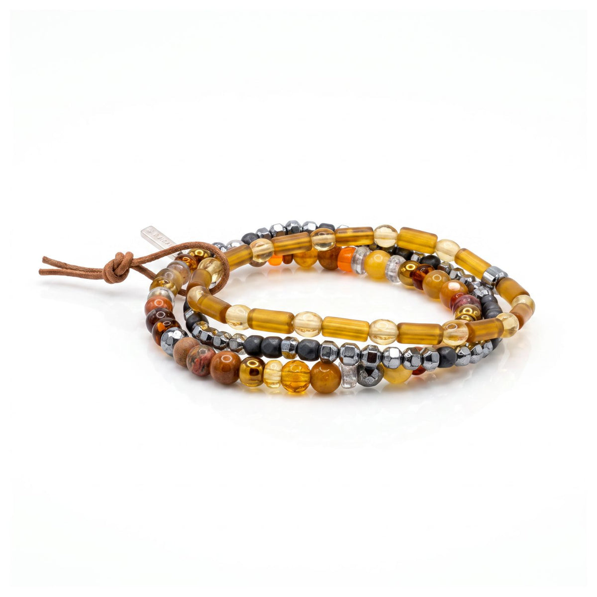 High-resolution studio product shot of the JAREDJAMIN Cyrus Men's 3-Piece Stackable Bracelet Set displayed together against a white backdrop, showing the amber glass beads, silver hematite, jasper, agate, and signature brown leather tie.