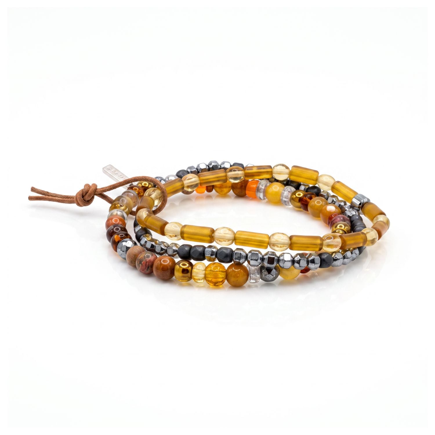 High-resolution studio product shot of the JAREDJAMIN Cyrus Men's 3-Piece Stackable Bracelet Set displayed together against a white backdrop, showing the amber glass beads, silver hematite, jasper, agate, and signature brown leather tie.