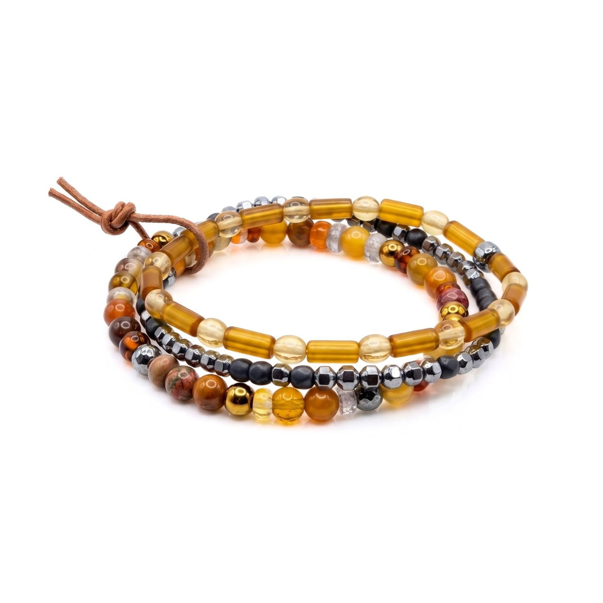 High-resolution studio shot of the Cyrus 3-piece men's stretch bracelet stack resting flat, displaying the silver-plated hematite, amber cylindrical glass, and natural jasper bead textures.