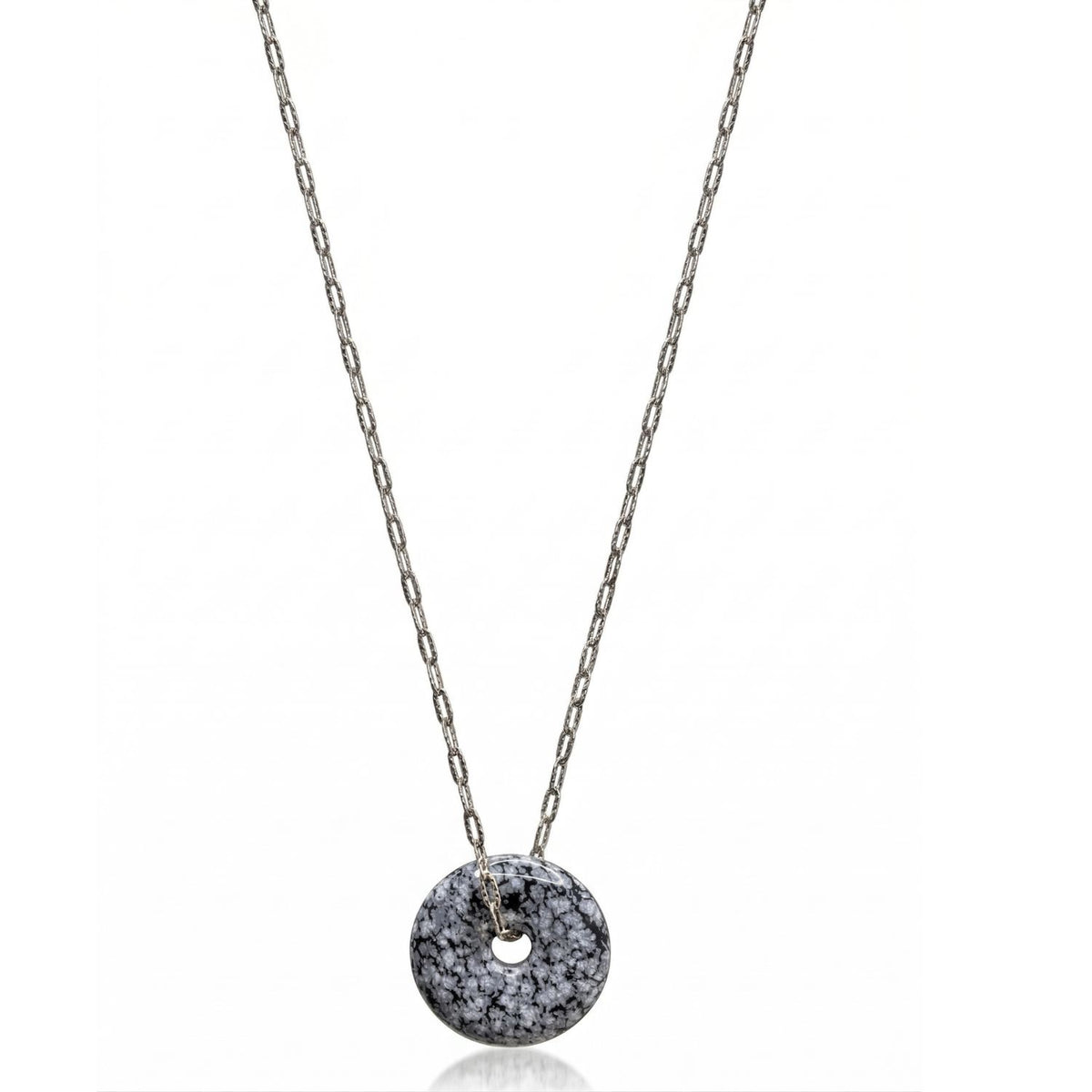 Hand-assembled in our West Hollywood studio, this sterling silver necklace frames a jasper disc scattered with black and white pigment. Produced in mindful small batches. Style Note: punctuates crisp shirting or evening knits with sculptural restraint.