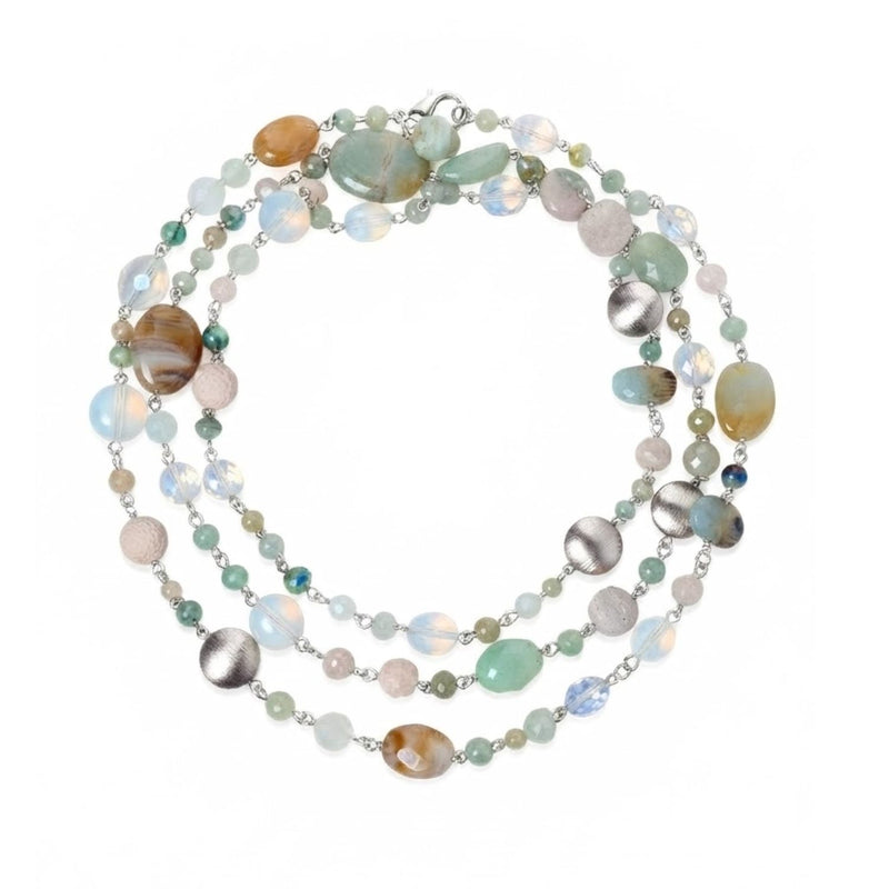 High-resolution studio product shot of the JAREDJAMIN Nerissa Convertible Strand coiled in a triple loop against a white backdrop, displaying the blues, aquas, and pale white tones of the amazonite, aquamarines, opals, and brushed silver disc beads.