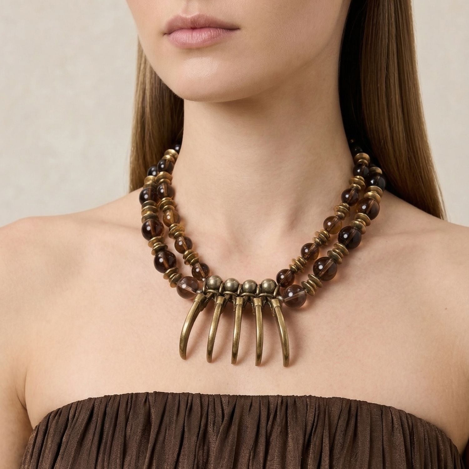 This necklace showcases dark round gemstone beads and gold rings, with brushed solid brass fan-shaped bone charms and a lobster clasp. Handmade in West Hollywood for low-impact, sustainable luxury—signature JAREDJAMIN Essential craftsmanship.