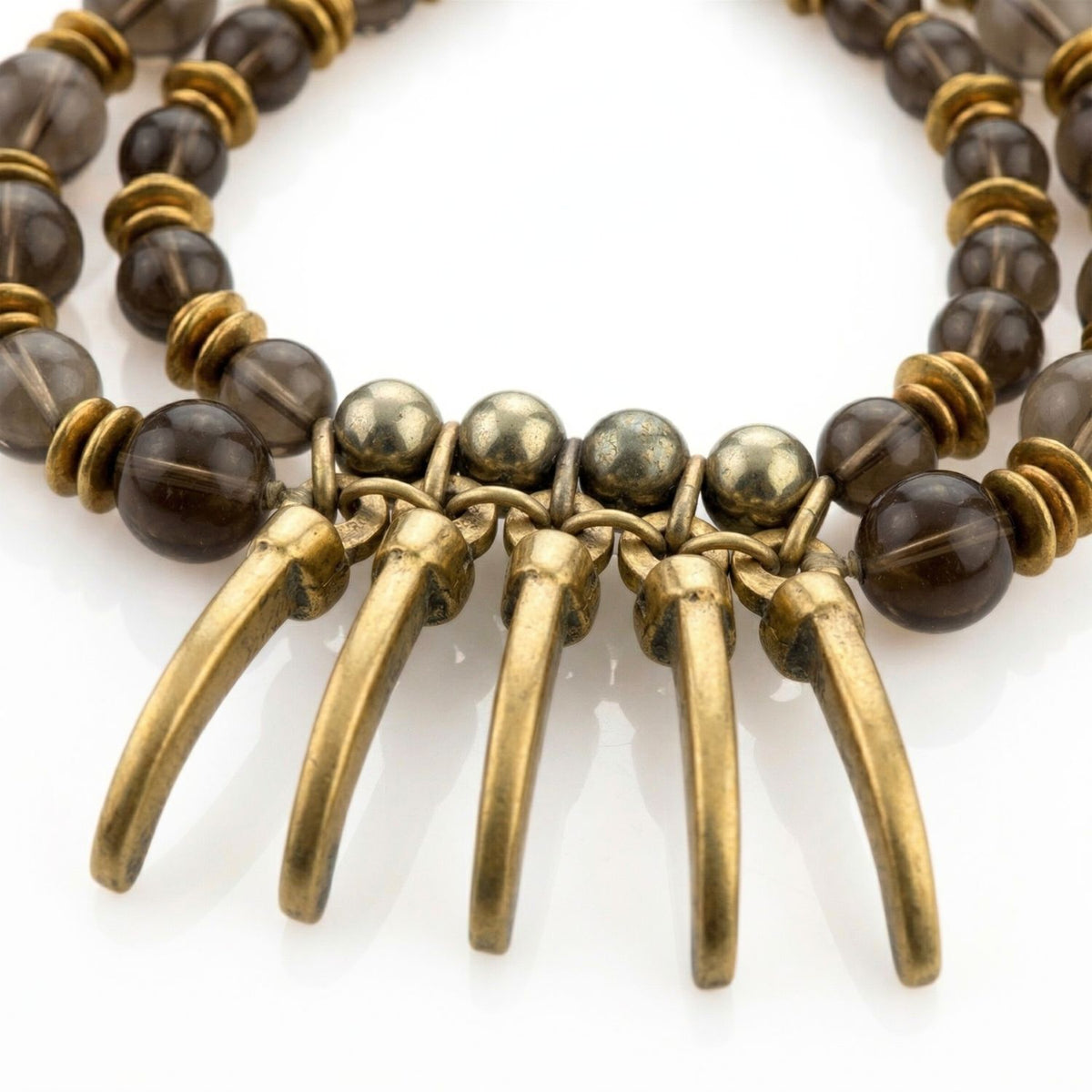 Valkyrie Gemstone Necklace by JAREDJAMIN: two strands of smoky brown round beads, gold spacers, five curved solid brass horn pendants. Brushed finishes, handcrafted in small batches West Hollywood, sustainable luxury. White background.