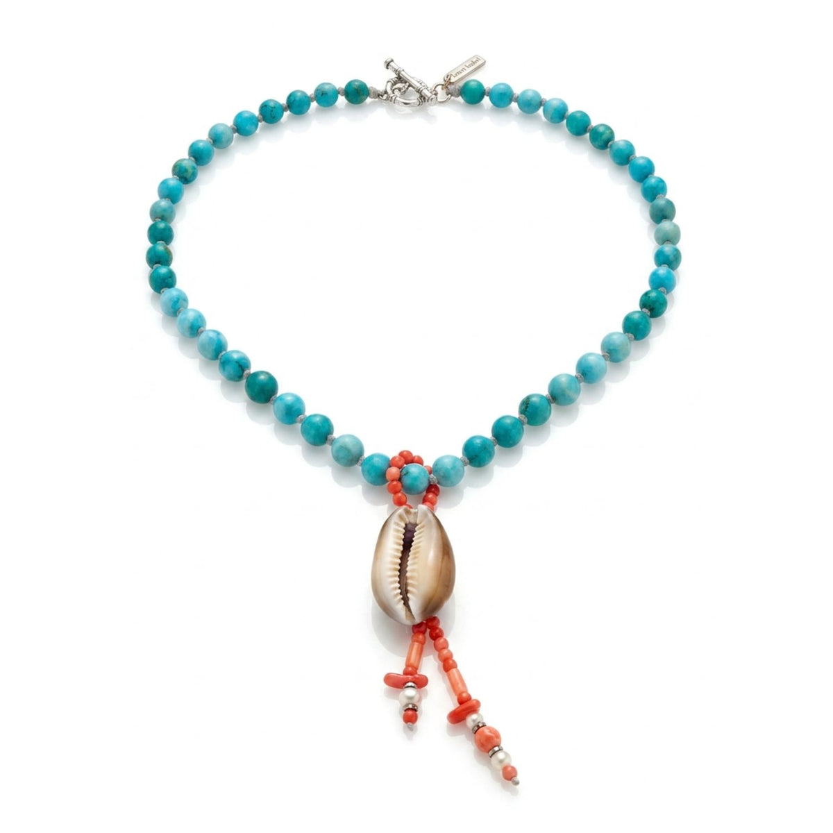 Alternate studio layflat shot of the Bimini Turquoise Necklace on a white background, showcasing the natural spotted pattern on the brown-backed cowrie shell and the silver-plated hematite accents along the coral drop.