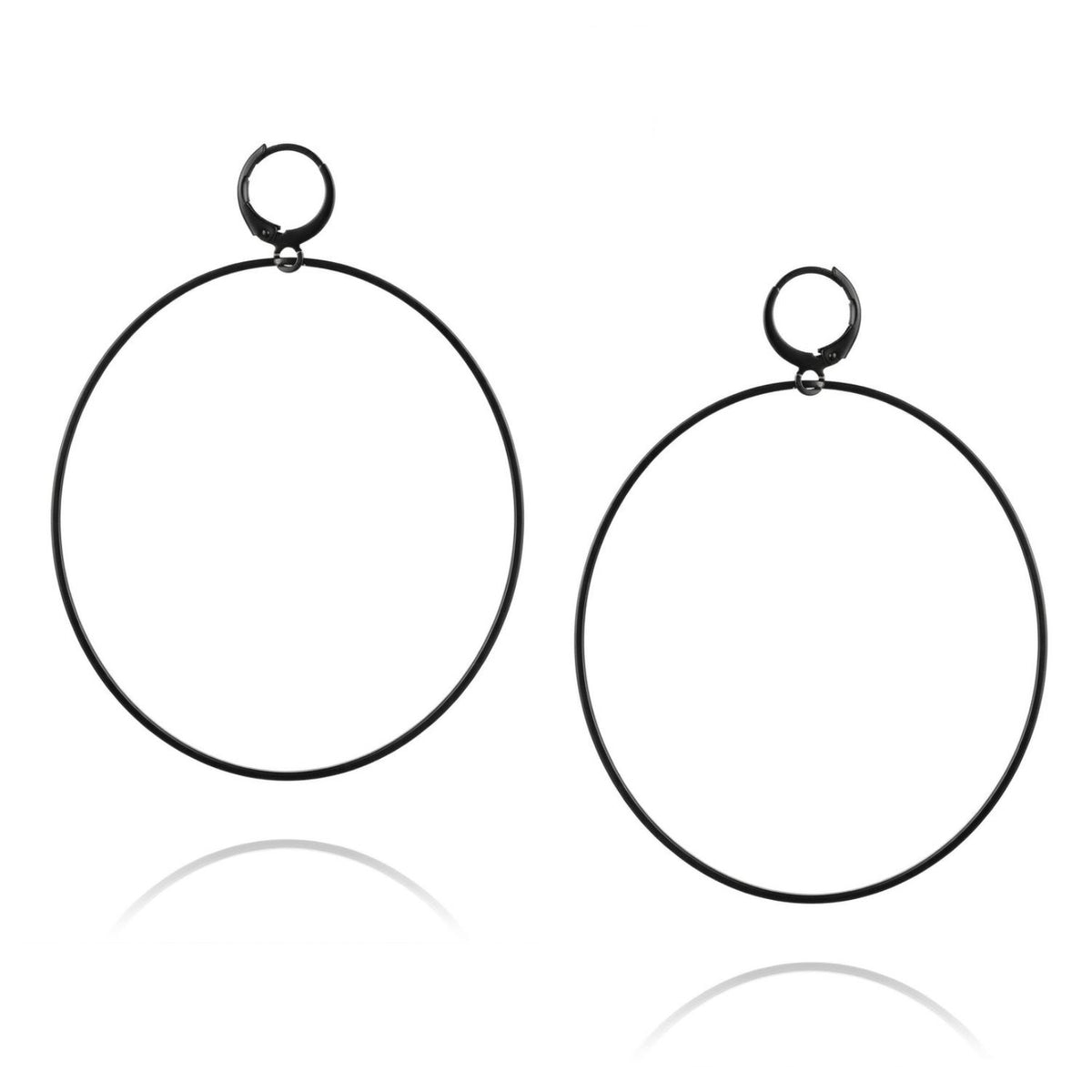 High-resolution studio product shot of the pair of JAREDJAMIN Nyx Black Halo Earrings against a crisp white backdrop, displaying their oversized circular shape and matte black finishes.