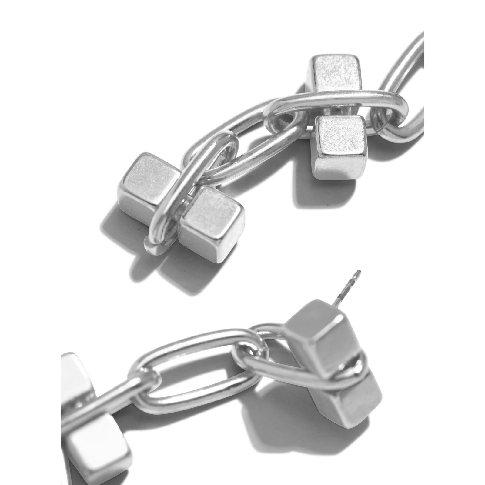 The Silver Blockbuster 3 Block Earrings by JAREDJAMIN Jewelry Online feature three silver-plated brass rectangular bars linked by oval chains for a modern, minimalist look. These dangle earrings have a shiny, polished finish and are shown on white.