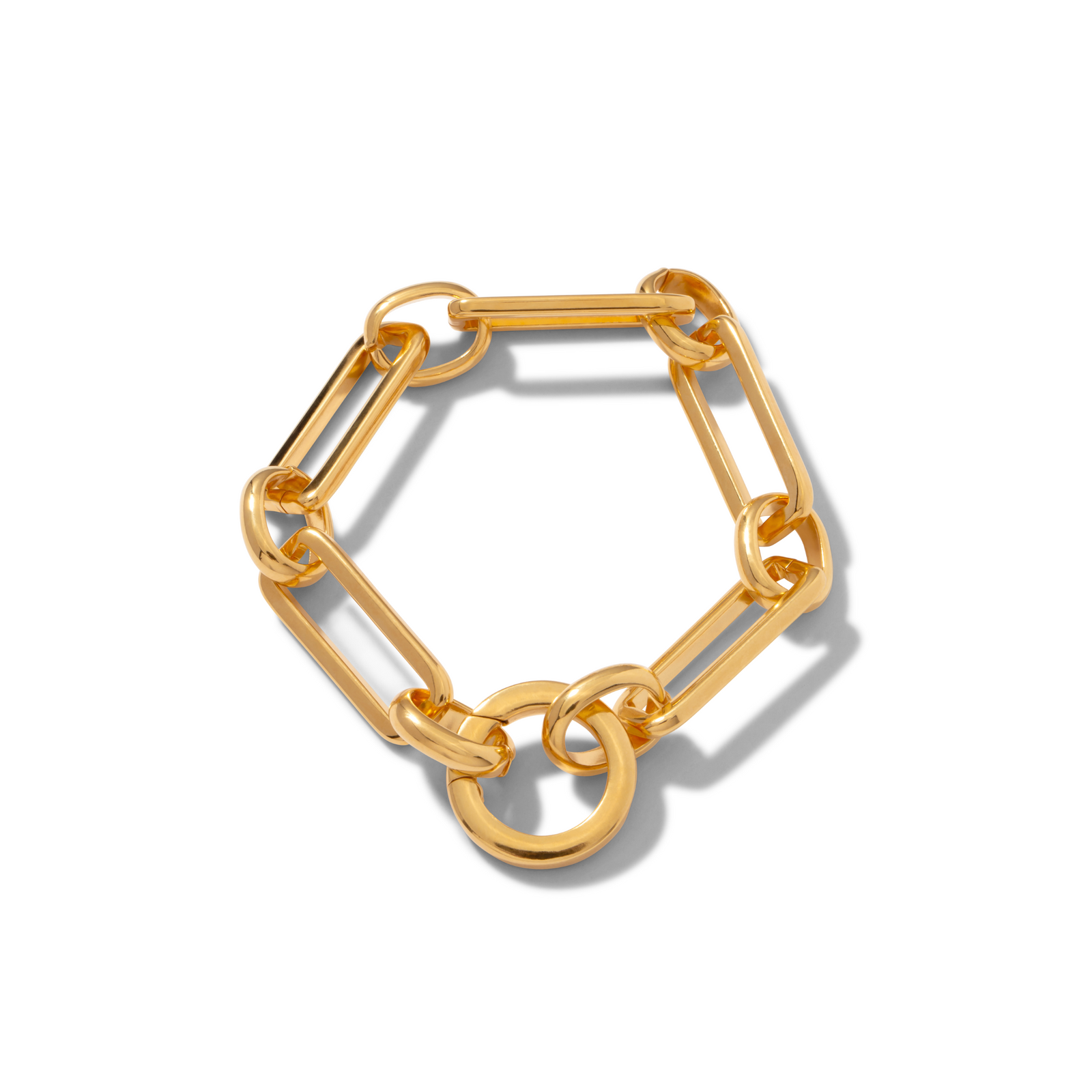 The Gold Bravura Link Chain Bracelet by JAREDJAMIN Jewelry Online features large, elongated gold-plated links with round loops and a bold detachable clicker clasp. Its shiny finish stands out against a white background.