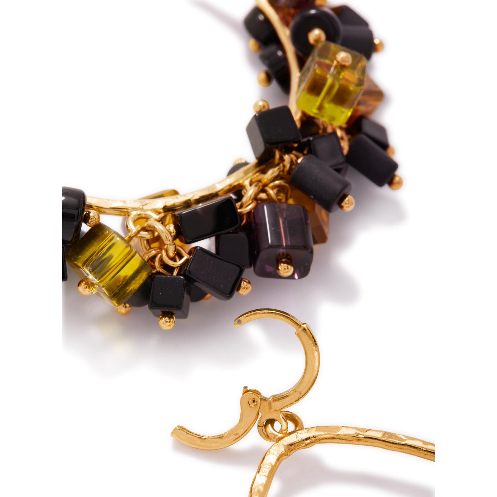 The Cubism Drop Loop Earrings by JAREDJAMIN Jewelry Online are large teardrop-shaped 18K gold plated hoops, featuring clusters of faceted glass beads in amber, black, olive green, and deep purple for a vibrant textured style.