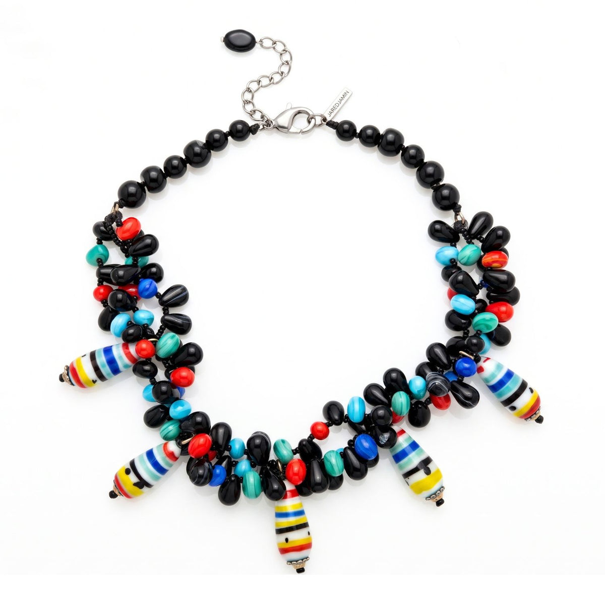High-resolution, top-down flat lay product shot of the JAREDJAMIN Candy Dandy Necklace on a white background, highlighting the hand-knotted twisted black onyx beads and the vibrant cluster of teardrop agate and striped vintage glass drops.