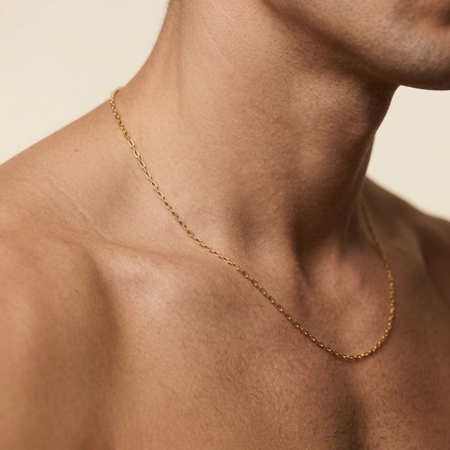 The Chandler Adjustable Chain Necklace by JAREDJAMIN Jewelry Online is a delicate 18K gold piece with a fine adjustable chain and a tiny engraved tag near the clasp, shown against a white background.