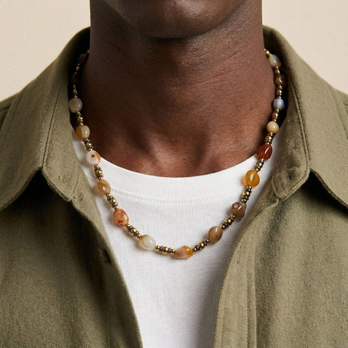 Hand-assembled in our West Hollywood studio, the Clayton Agate Necklace refracts earthy brown, gold, and cream beads—punctuated by a silver-plated clasp. Our small-batch, eco-conscious approach sculpts versatility: style with denim or silk after dusk.
