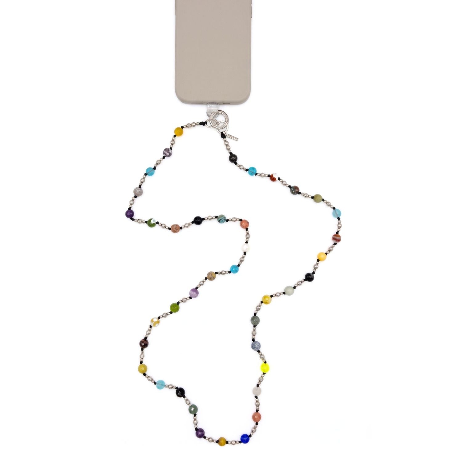High-resolution studio product shot of the JAREDJAMIN Prism Cross-Body Gemstone Phone Lanyard clipped to a phone against a white background, highlighting the multicolored faceted gemstones, black knots, and silver clicker clasp.
