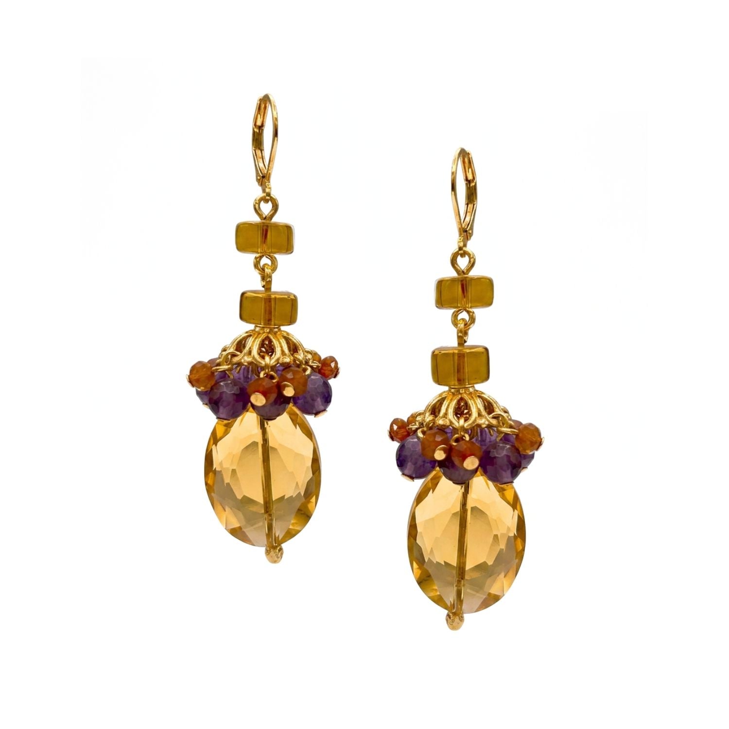 High-resolution studio product shot of the JAREDJAMIN Copacabana Dangle Earrings, showcasing the gold-finished lever-backs, stacked circular amber glass beads, and the large faceted amber crystals adorned with clustered amethyst and carnelian charms against a white backdrop.