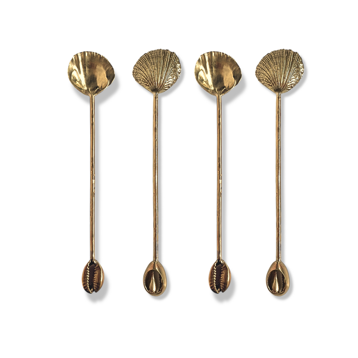 The Silver Cockle &amp; Cowrie Condiment Spoons Set by JAREDJAMIN Barware and More includes four elegant metal spoons. With long handles and unique seashell designs—two fan-shaped, two cowrie—they enhance any sophisticated table setting against a plain white background.