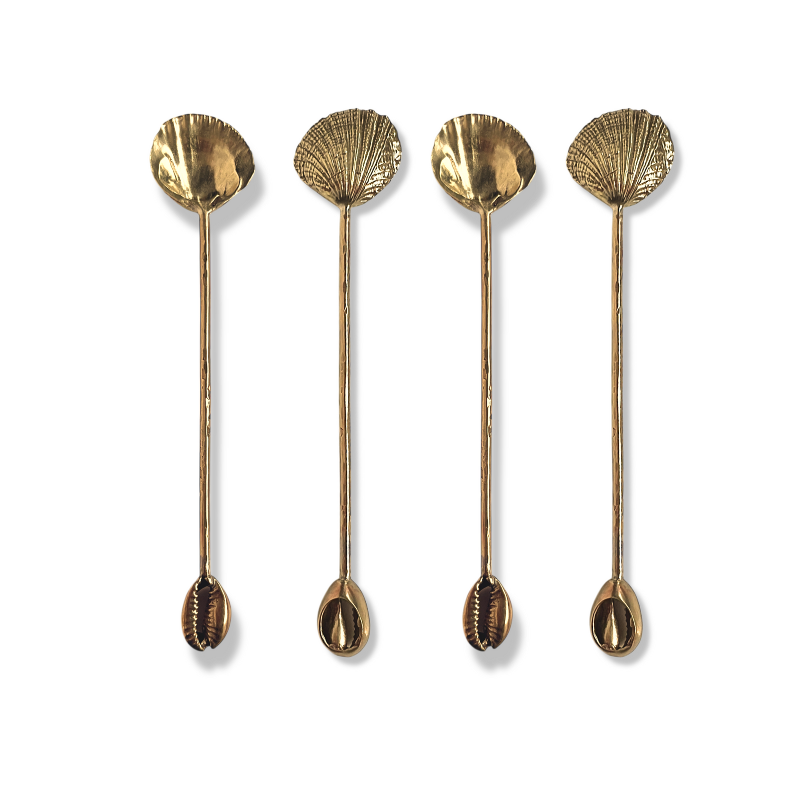 The Silver Cockle  Cowrie Condiment Spoons Set by JAREDJAMIN Barware and More showcases four silver-plated spoons with seashell bowls and cowrie shell handles, adding elegant coastal style to your table setting.