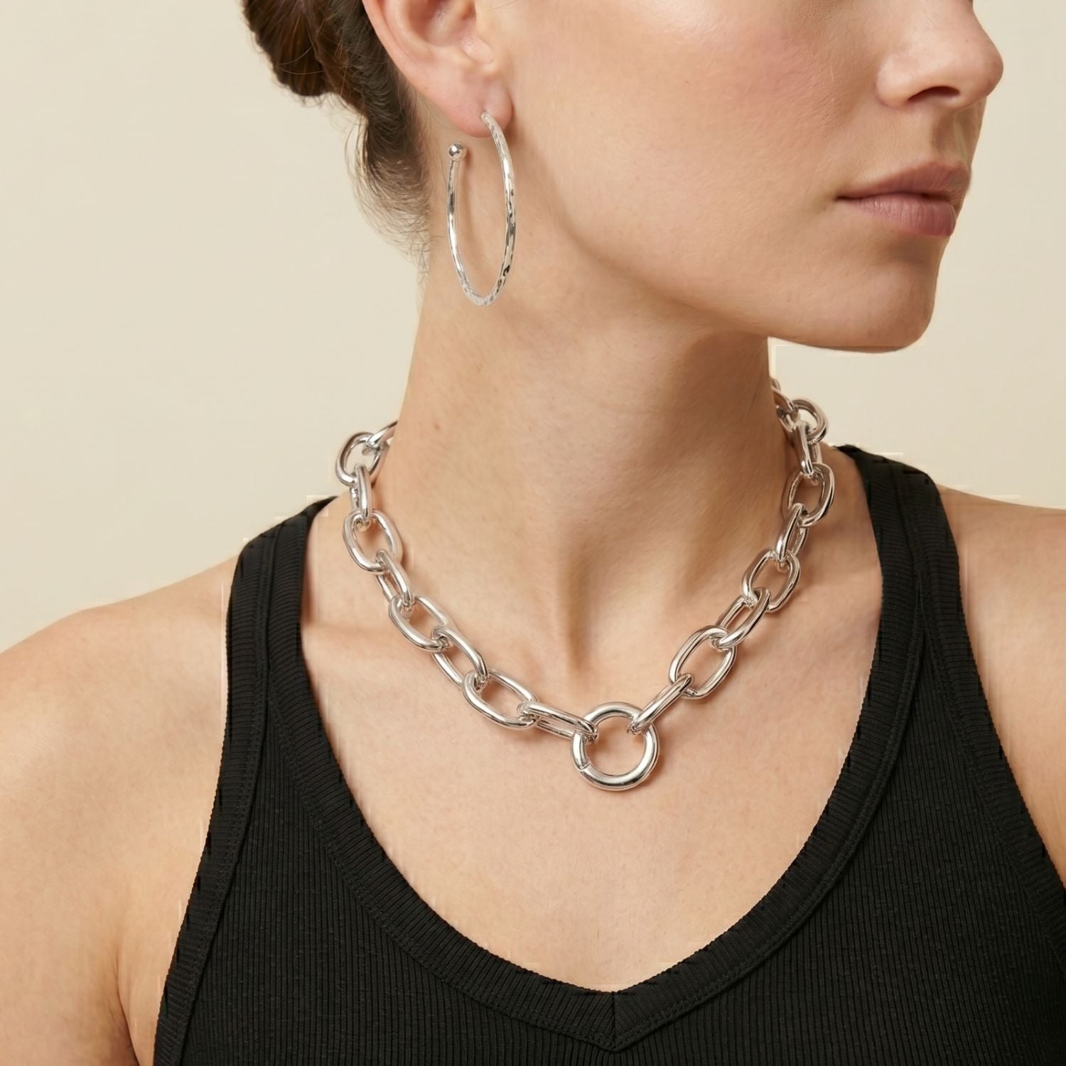 The Silver Everly Chain Necklace by JAREDJAMIN Jewelry Online features large silver-plated oval links in a teardrop shape, accented with a central round ring for an industrial touch and polished for a modern, minimalist look.