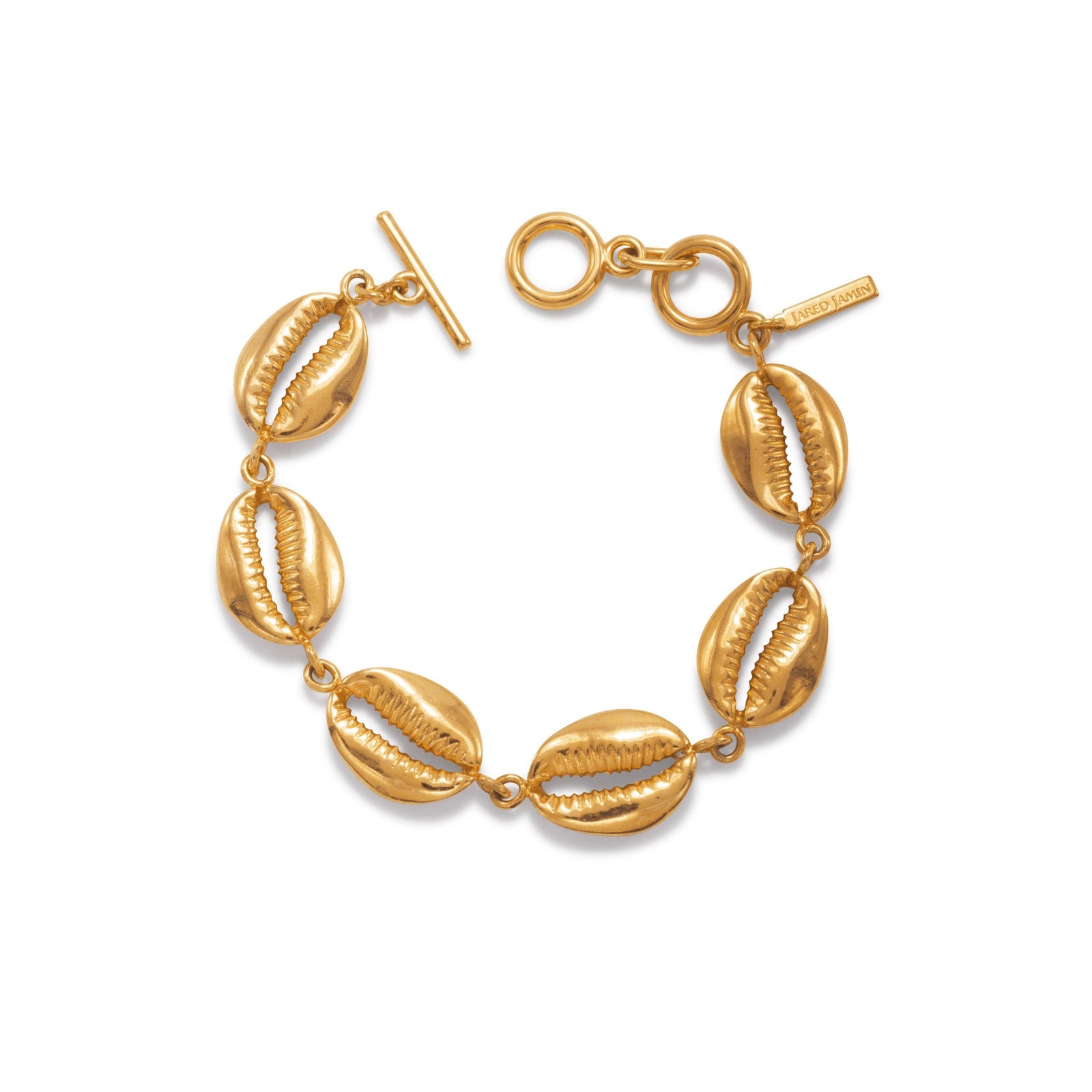 The Gold Bel Mare Cowrie Seashell Bracelet by JAREDJAMIN Jewelry Online features five detailed 18K gold-plated cowrie shell charms, evenly spaced on a toggle chain with a signature engraved tag for an elegant, ocean-inspired look.