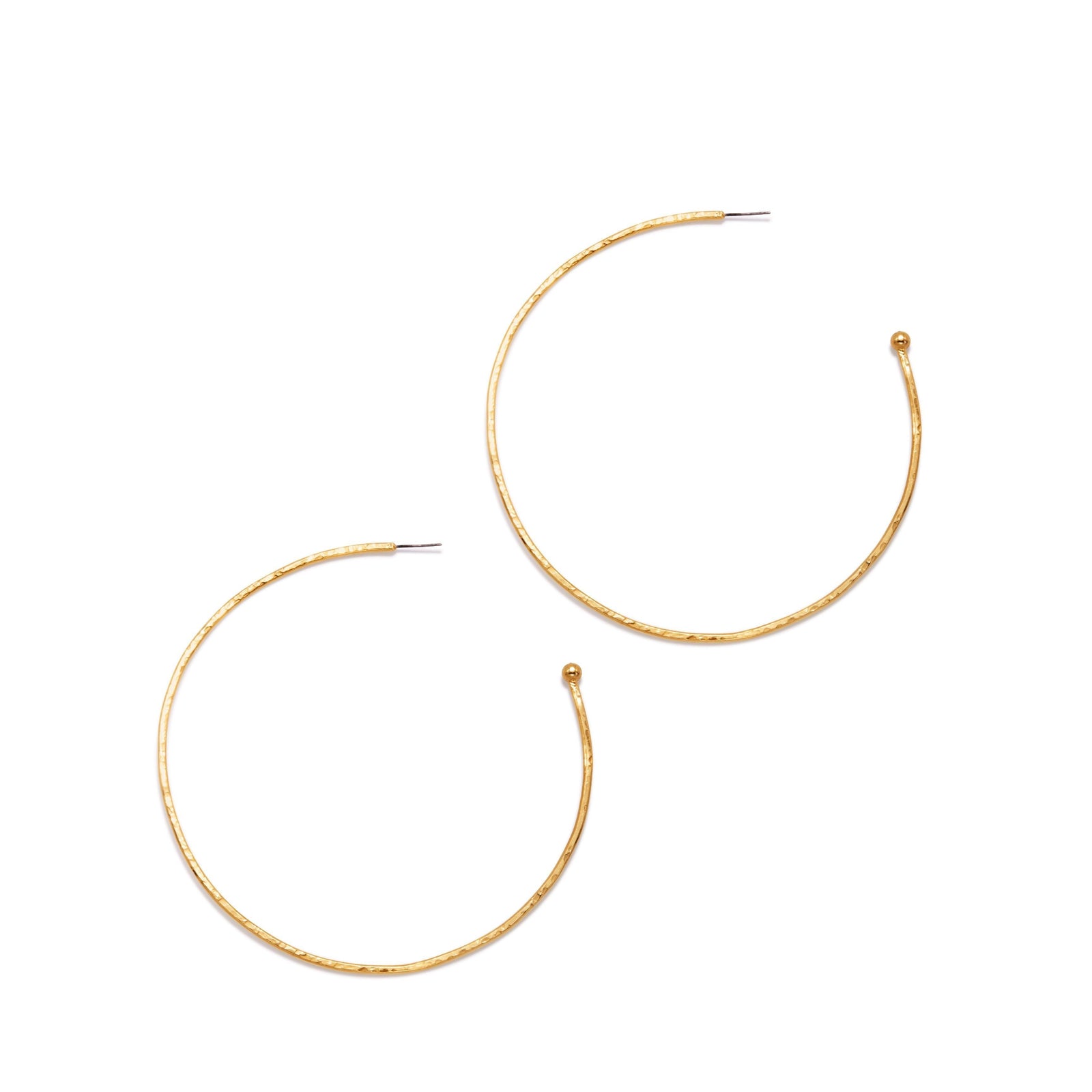Gold Large Hooptastic Hoop Post Earrings by JAREDJAMIN Jewelry Online: two large, thin 18K gold hoops with a hammered texture, incomplete circles with a tapered end and post fastener. Shown on a plain white background.