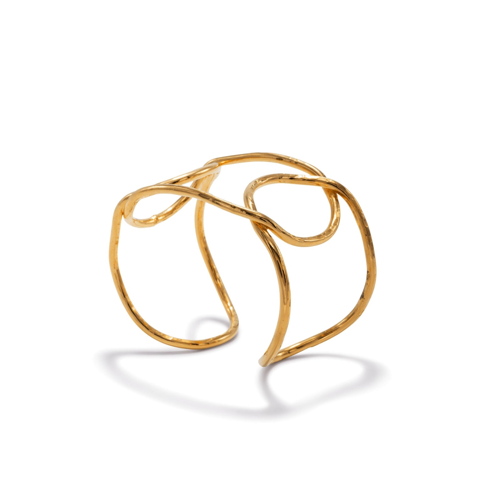 The Gold Pretzel Cuff Bracelet by JAREDJAMIN Jewelry Online features hammered 18K gold plate, overlapping loops, and open pretzel-like twists in an asymmetrical design. One size fits most with an 8" circumference.