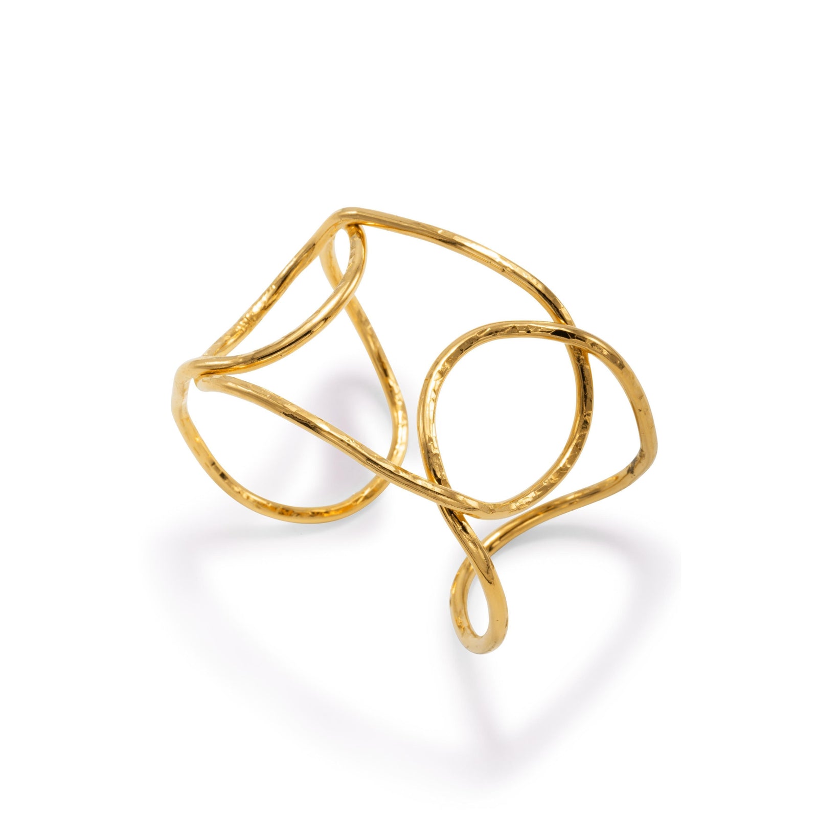 The Gold Pretzel Cuff Bracelet by JAREDJAMIN Jewelry Online features hammered 18K gold plate, overlapping loops, and open pretzel-like twists in an asymmetrical design. One size fits most with an 8" circumference.