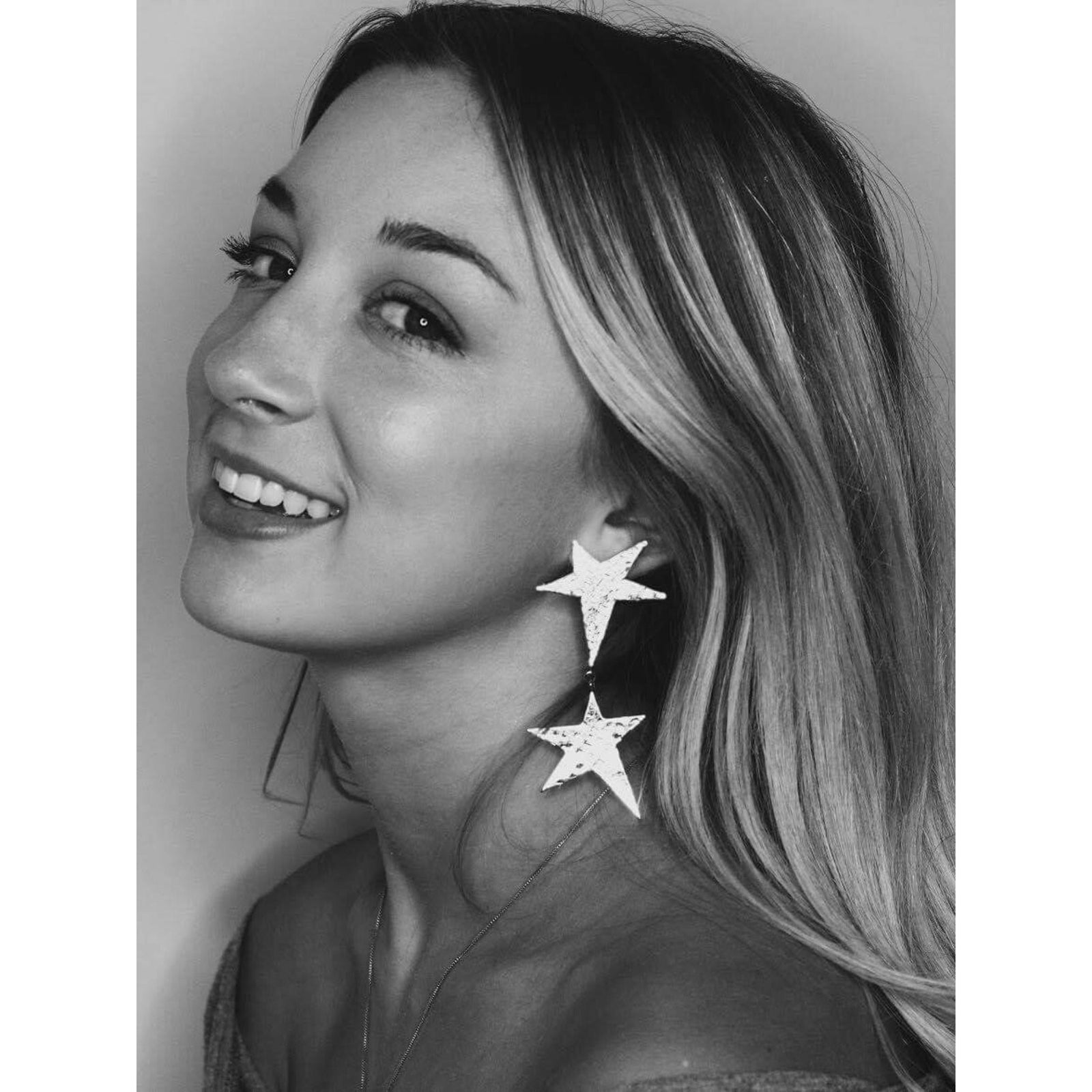 The Silver Shooting Star Dangle Post Earrings by JAREDJAMIN Jewelry Online feature two hammered five-pointed stars linked by a small ring. Lightweight and eye-catching, they shimmer beautifully on a white background—ideal for New Year's celebrations.
