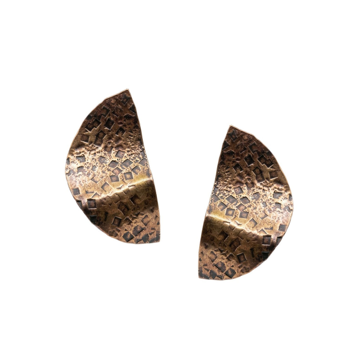 The Geo Twist Antique Tone Medium Earrings by JAREDJAMIN Jewelry Online feature two hammered bronze semicircles with a textured geometric pattern and mixed tones, arranged with flat edges facing each other on a white background.