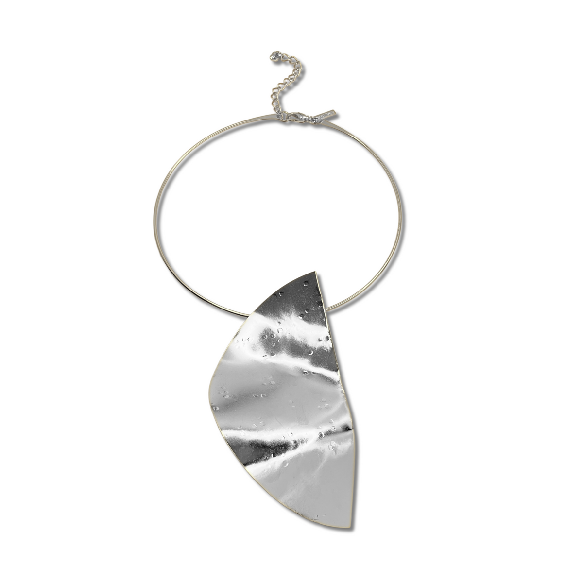 The Geo Twist Pendant Neck Wire by JAREDJAMIN Jewelry Online is a silver choker with a large, hammered metal pendant resembling a folded leaf. Its shiny, textured surface and adjustable clasp ensure an elegant look and perfect fit.