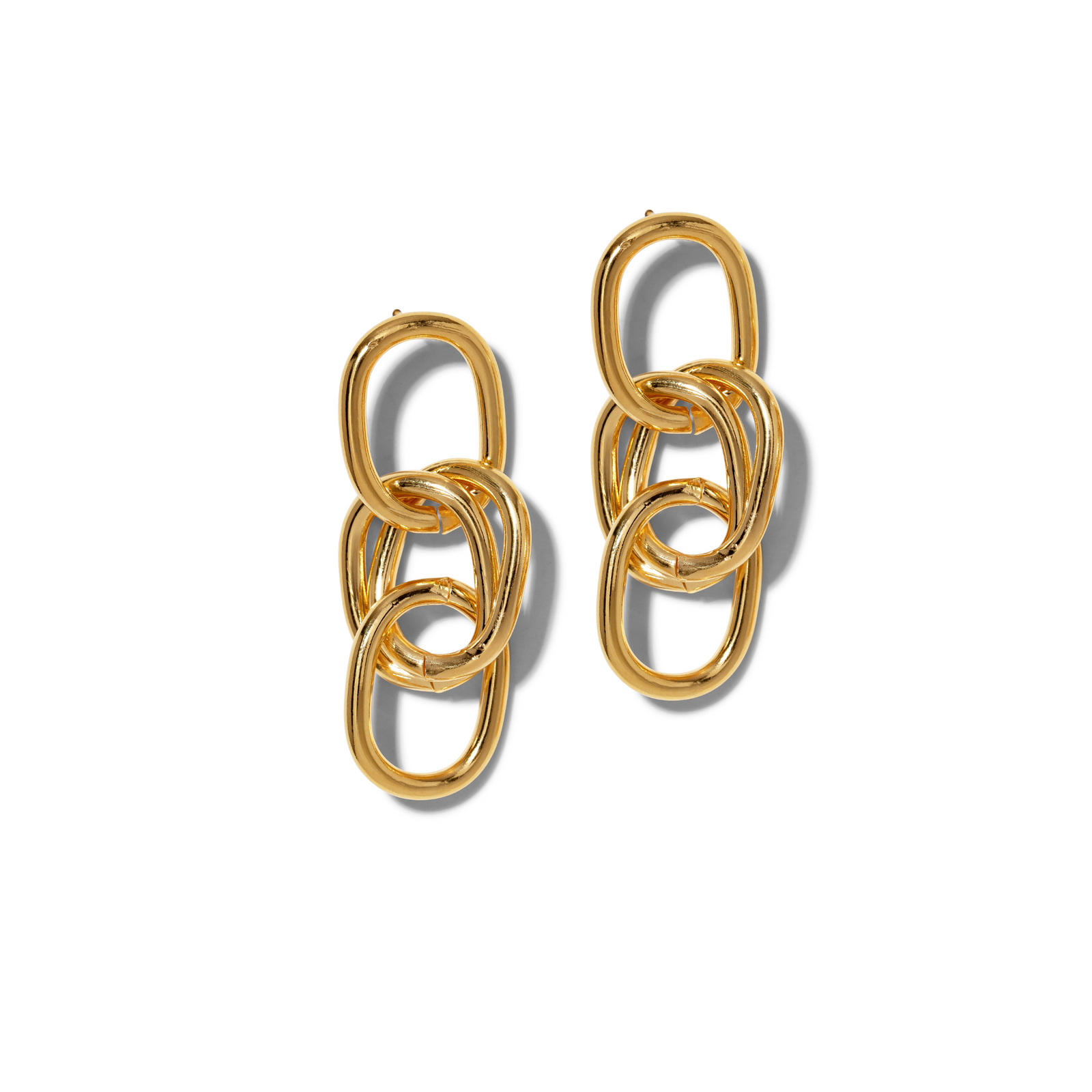 The Gold Billie Drop Post Earrings from JAREDJAMIN Jewelry Online feature three vertically arranged, interlocking oval links with a polished finish, offering a classic chic look and subtle shadows on a white background.