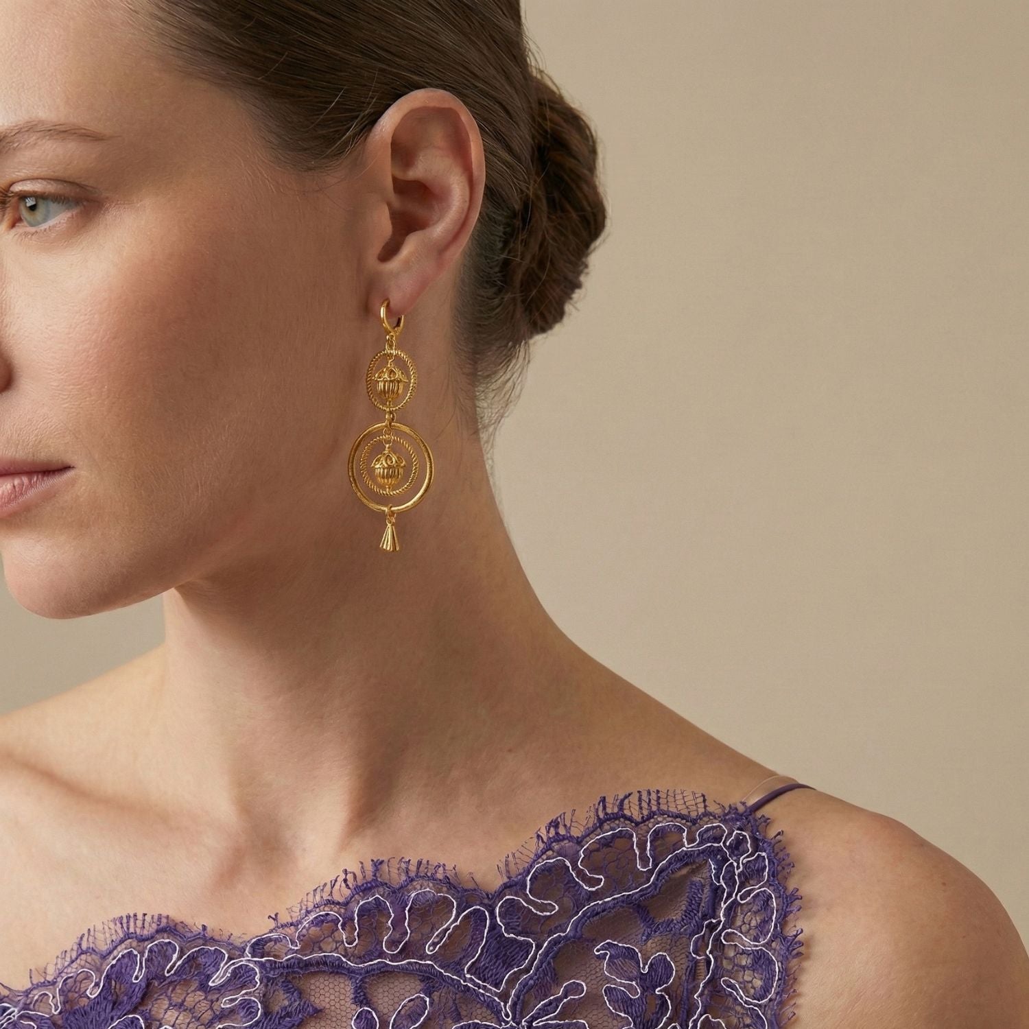 JAREDJAMIN Jewelry Online's Gold Bollywood Dangle Leverback Earrings feature two textured concentric circles with ribbed dome charms and a gold cone-shaped pendant, all in 18K gold plating and a polished finish.