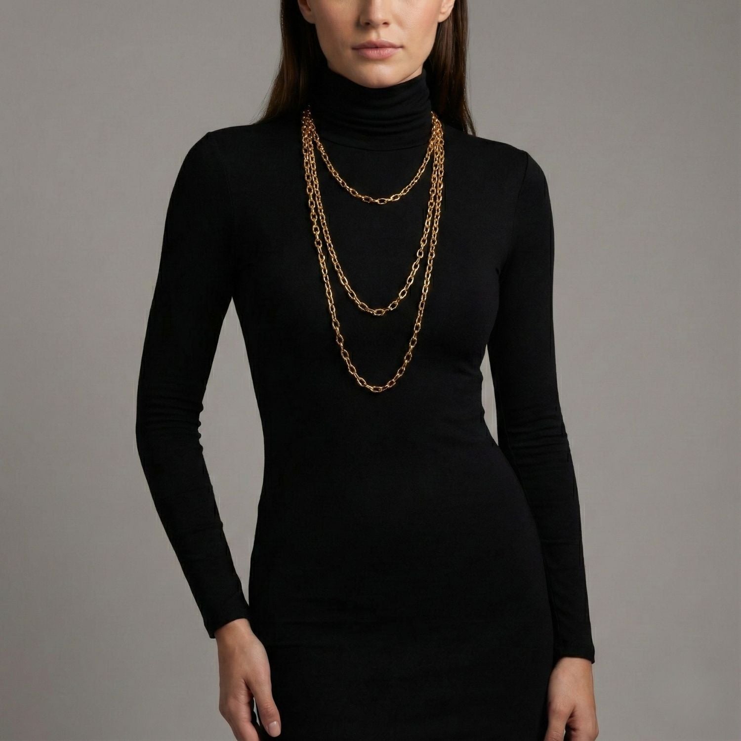 The Gold Chain Reaction Necklace from JAREDJAMIN Jewelry Online features 18K gold-plated elongated oval links in a lariat style with a circular ring and dangling bar, finished with a lobster clasp. Displayed on a plain white background.