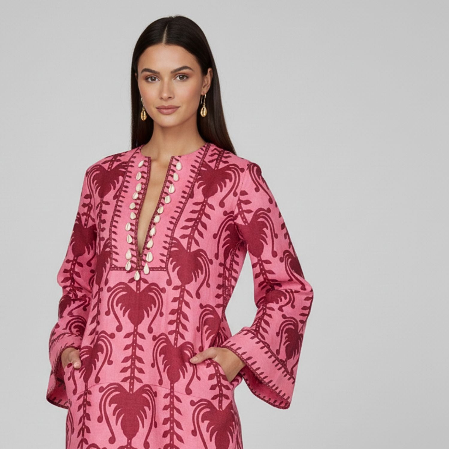 The Gold Cowrie French Hook Earrings by JAREDJAMIN Jewelry Online feature polished brass shells with detailed grooves, hanging from simple hooks. Shown on a plain white background.