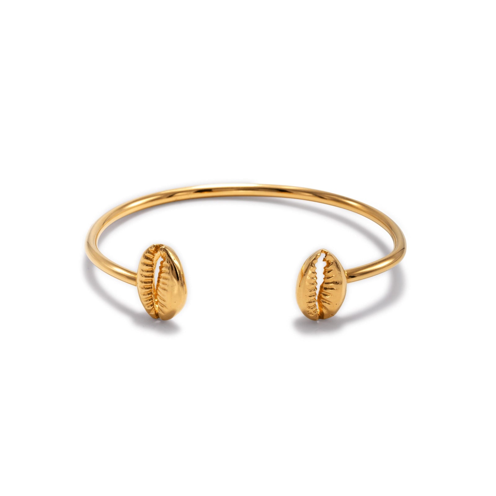 The Gold Cowrie Shell Cuff Bracelet from JAREDJAMIN Jewelry Online features an 18K gold, polished thin band with two cowrie shell-shaped ends for a textured, beach-inspired look.