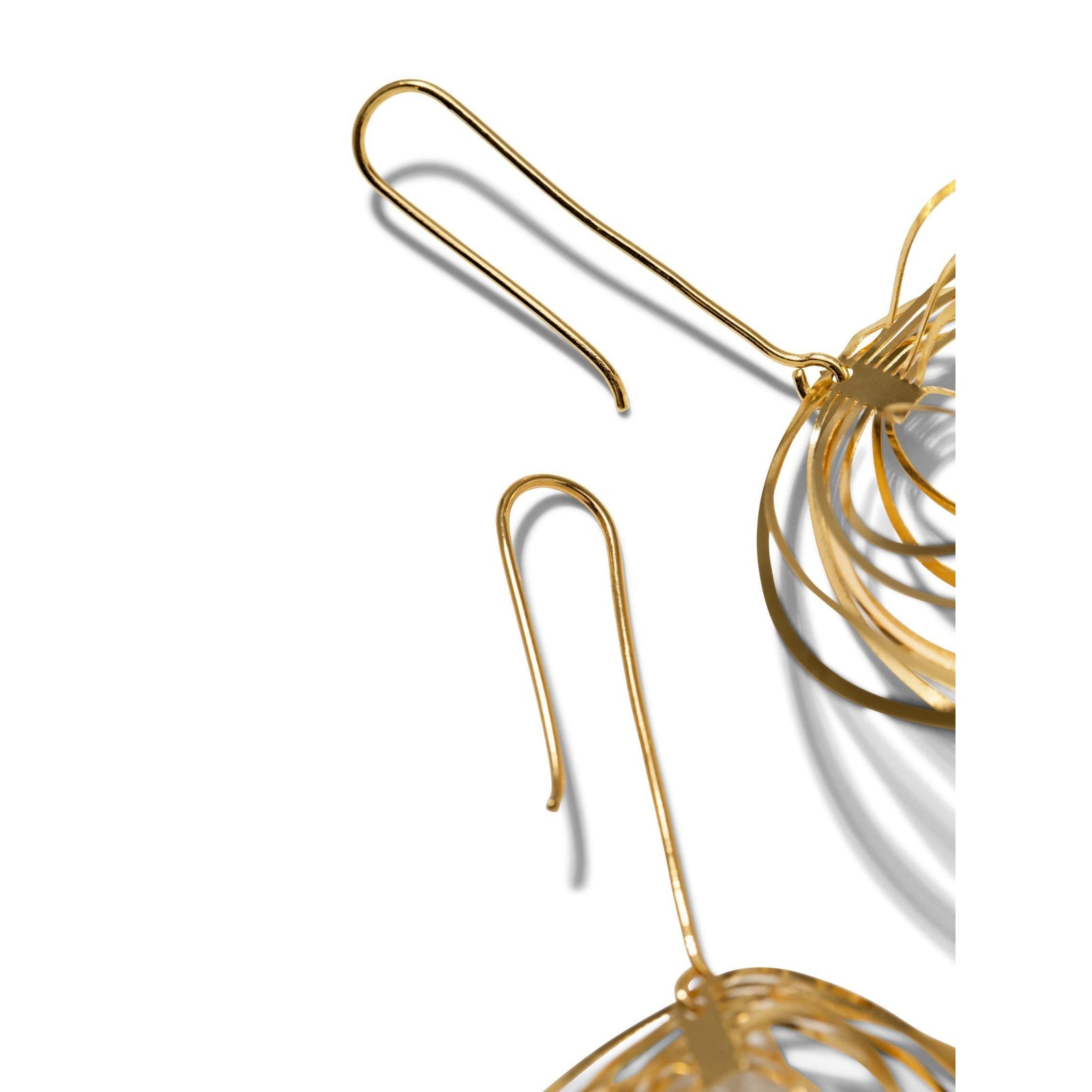 The Gold Dahlia Hook Earrings by JAREDJAMIN Jewelry Online feature multiple interlocking hammered loops in a layered spiral design, finished in 18K gold plate and hanging from simple French hooks.