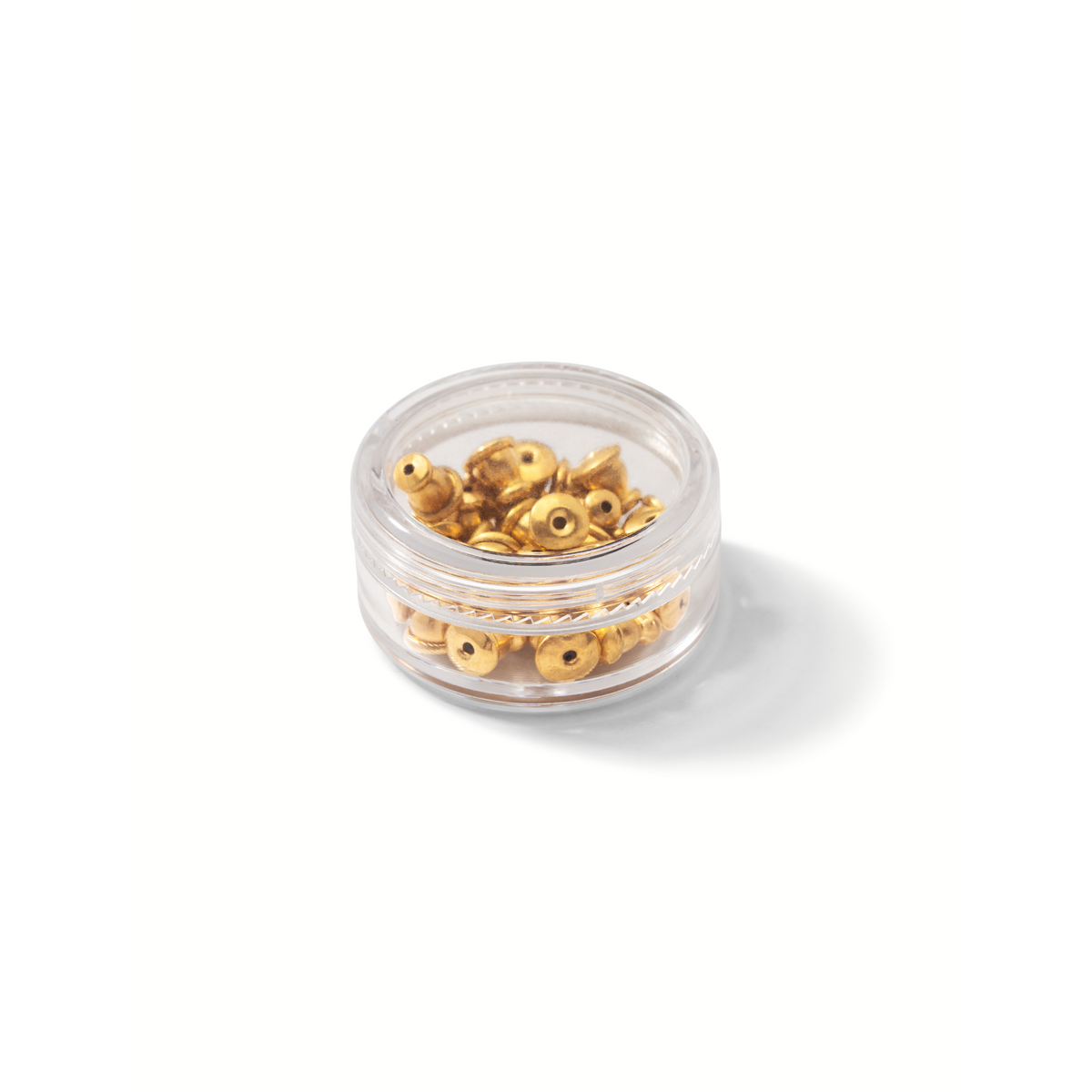 Un small clear container de JAREDJAMIN Bijoux en Ligne holds brillant or boucle d'oreille Backings. Sitting sur un white surface, the neatly stacked backings catch the light et showcase their metallic finish.