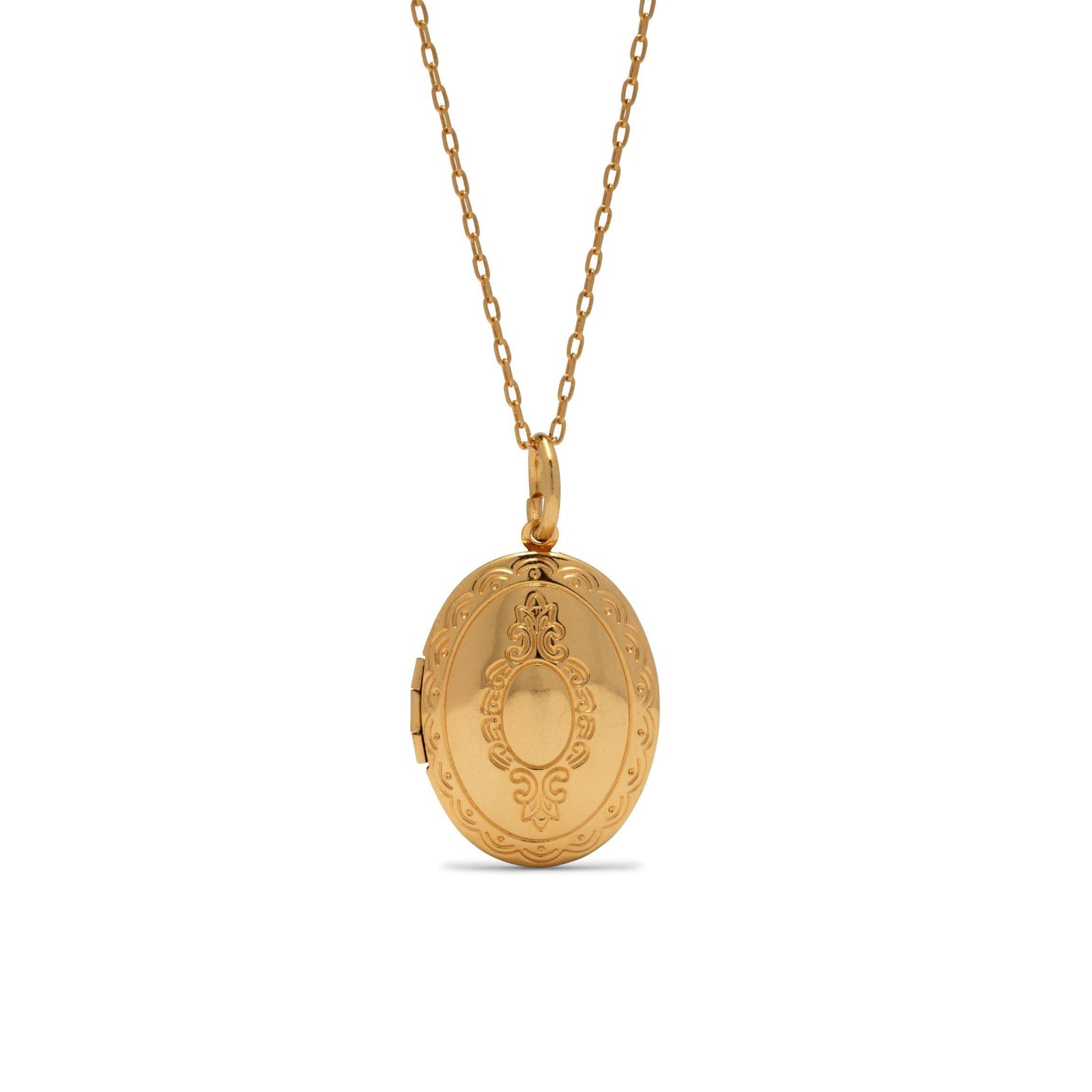 The Gold Edwardian Necklace Pendant Locket by JAREDJAMIN Jewelry Online features a vintage 18K gold plate oval design with engraved scrollwork and a central smooth area, hanging from a fine chain. The locket is closed and exudes elegant charm.