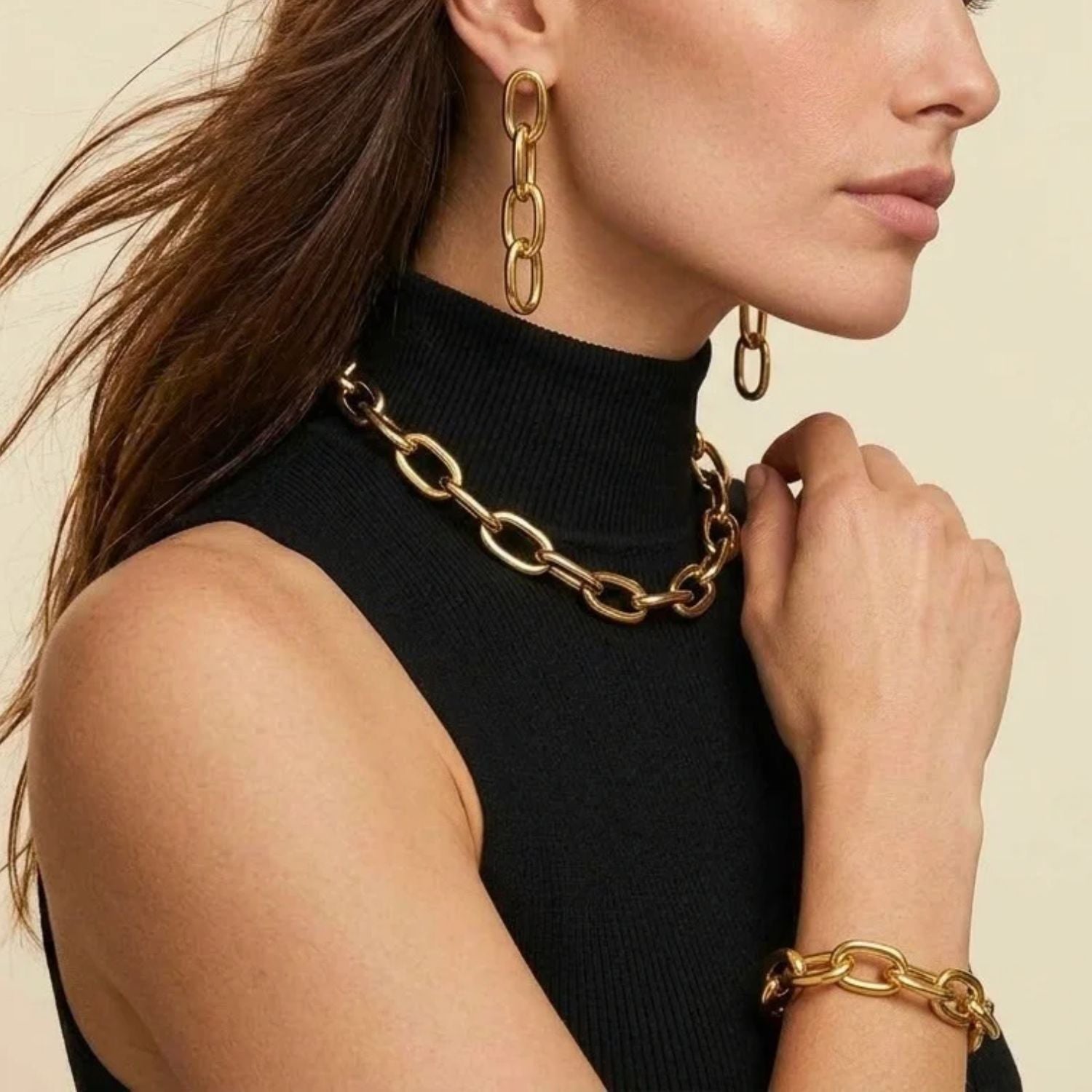 The Gold Everly Link Chain Bracelet by JAREDJAMIN Jewelry Online features large oval links, a polished gold-plated shine, and a round detachable clicker clasp. Shown arranged in a partial circle on a white background.