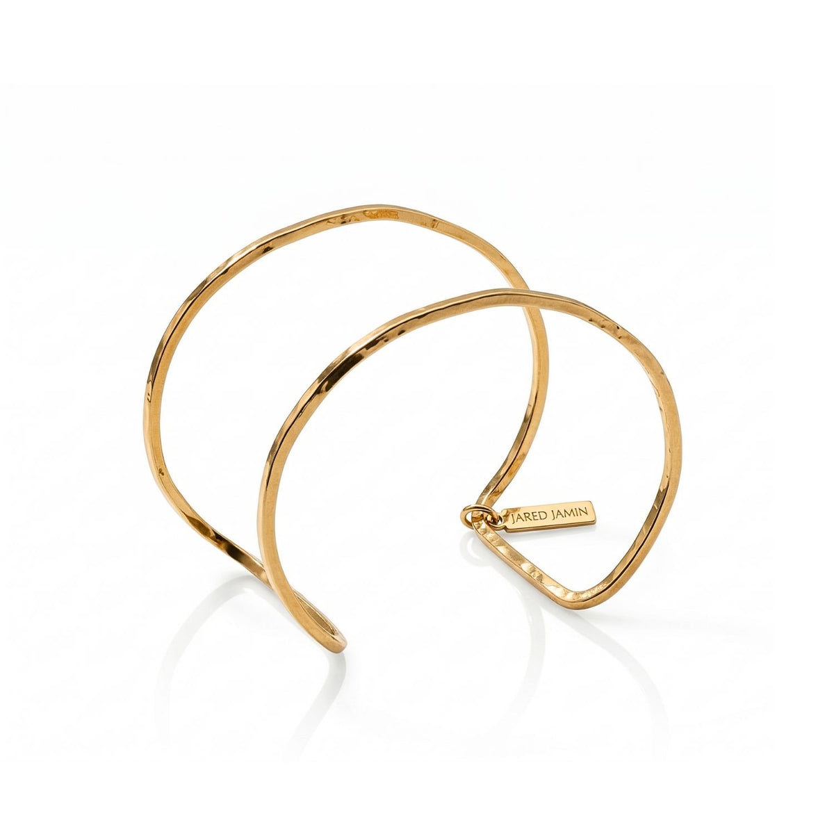 Gold Halo Forge Textured Cuff—sculpted by hand in our West Hollywood studio—captures undulating bands of hammered gold, punctuated by a discreet JARED JAMIN tag. Crafted in eco-conscious, small-batch form. Style Note: transitions from crisp denim to silk eveningwear.