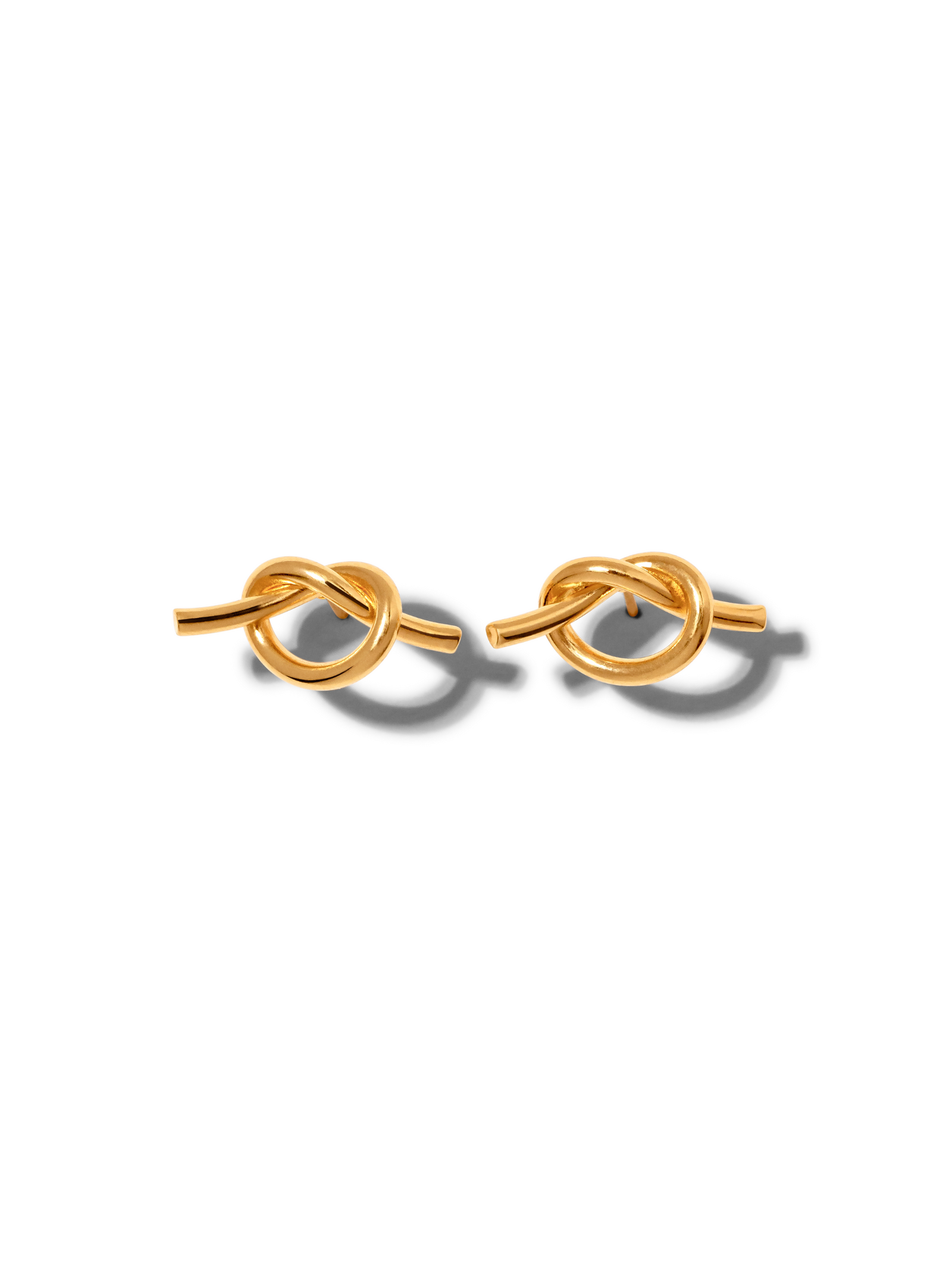 Gold Why Knot Stud Post Earrings by JAREDJAMIN Jewelry Online feature elegant knot-shaped designs in 18K gold plating, with a smooth, polished finish that highlights their sophisticated style.