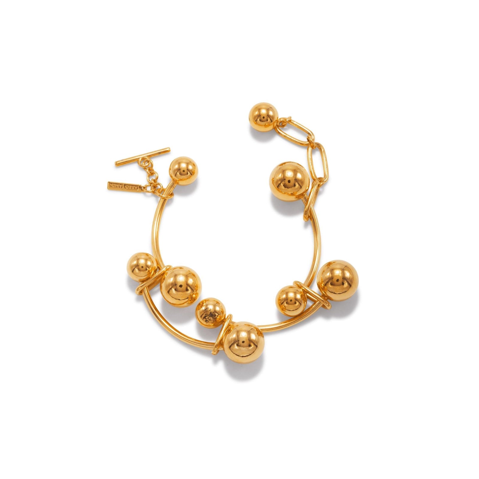 The Gold Orbita Nova Link Bracelet by JAREDJAMIN Jewelry Online features seven large round beads on an undulating chain with a chunky toggle clasp and a small tag, all in polished 18K gold plate, shown on a white background.
