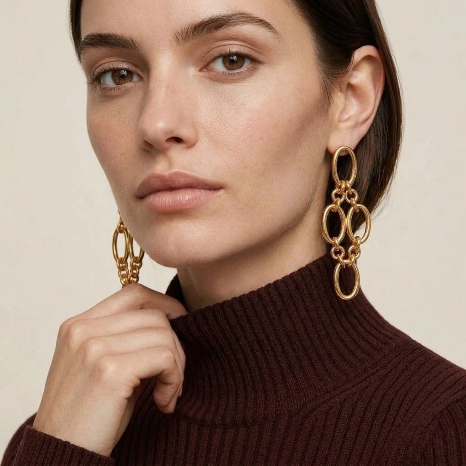 The Gold Ophelia Drop Post Earrings by JAREDJAMIN Jewelry Online feature five interlinked oval 18K gold plated loops in a chic, mountain-inspired geometric design, elegantly displayed on a white background.