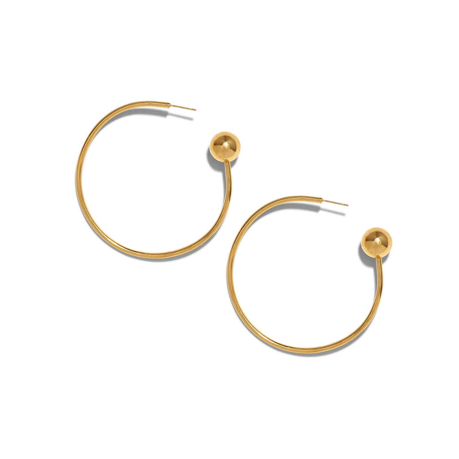The Gold Orbita Comet Earrings by JAREDJAMIN Jewelry Online are 18K gold hoops with a minimalist design, each featuring a thin circular hoop and a polished gold sphere at the end, displayed on a white background.