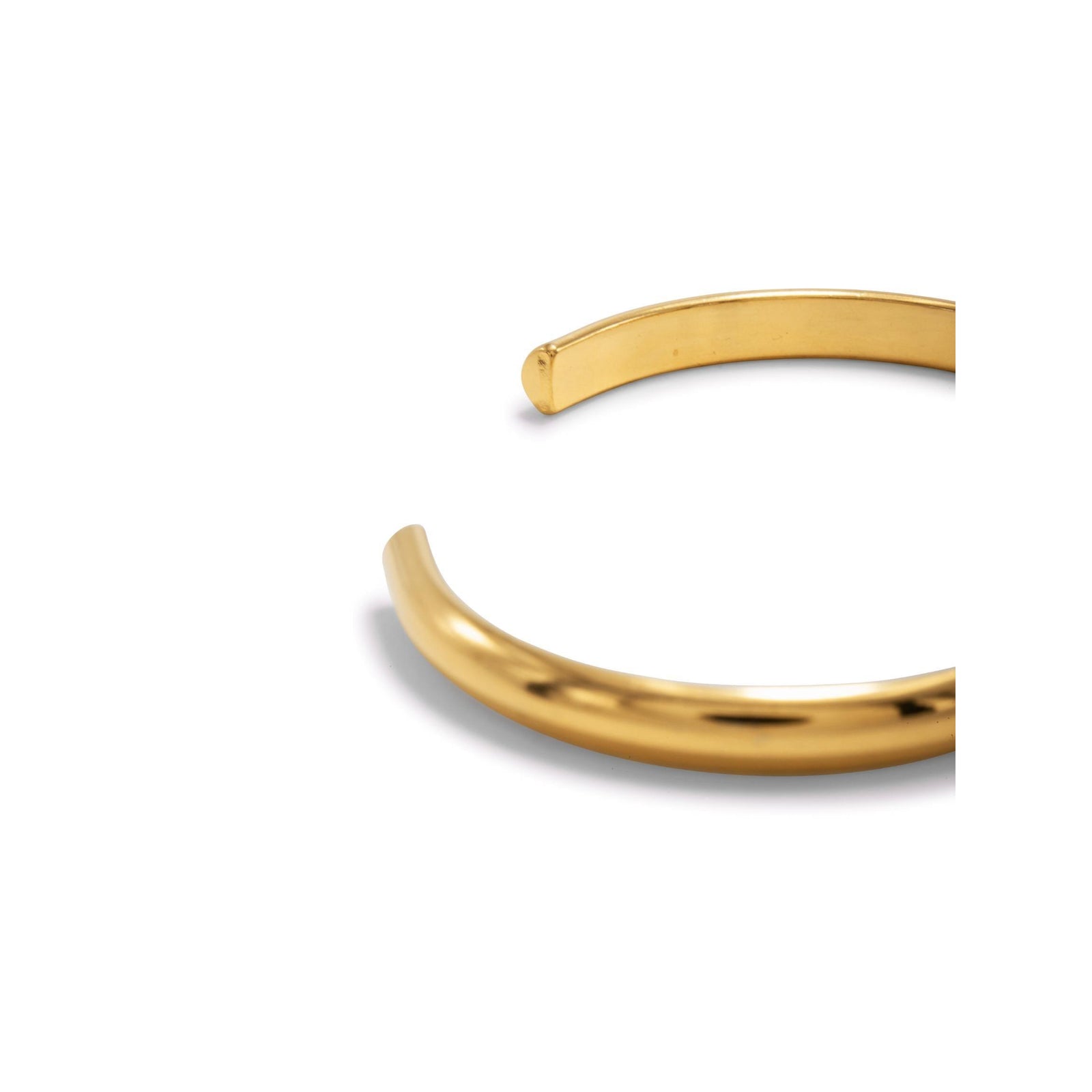 The Gold Parker Cuff by JAREDJAMIN Jewelry Online is an open-ended 18K gold plated bracelet with straight, unfinished ends and a smooth, polished finish for an understated, modern look.